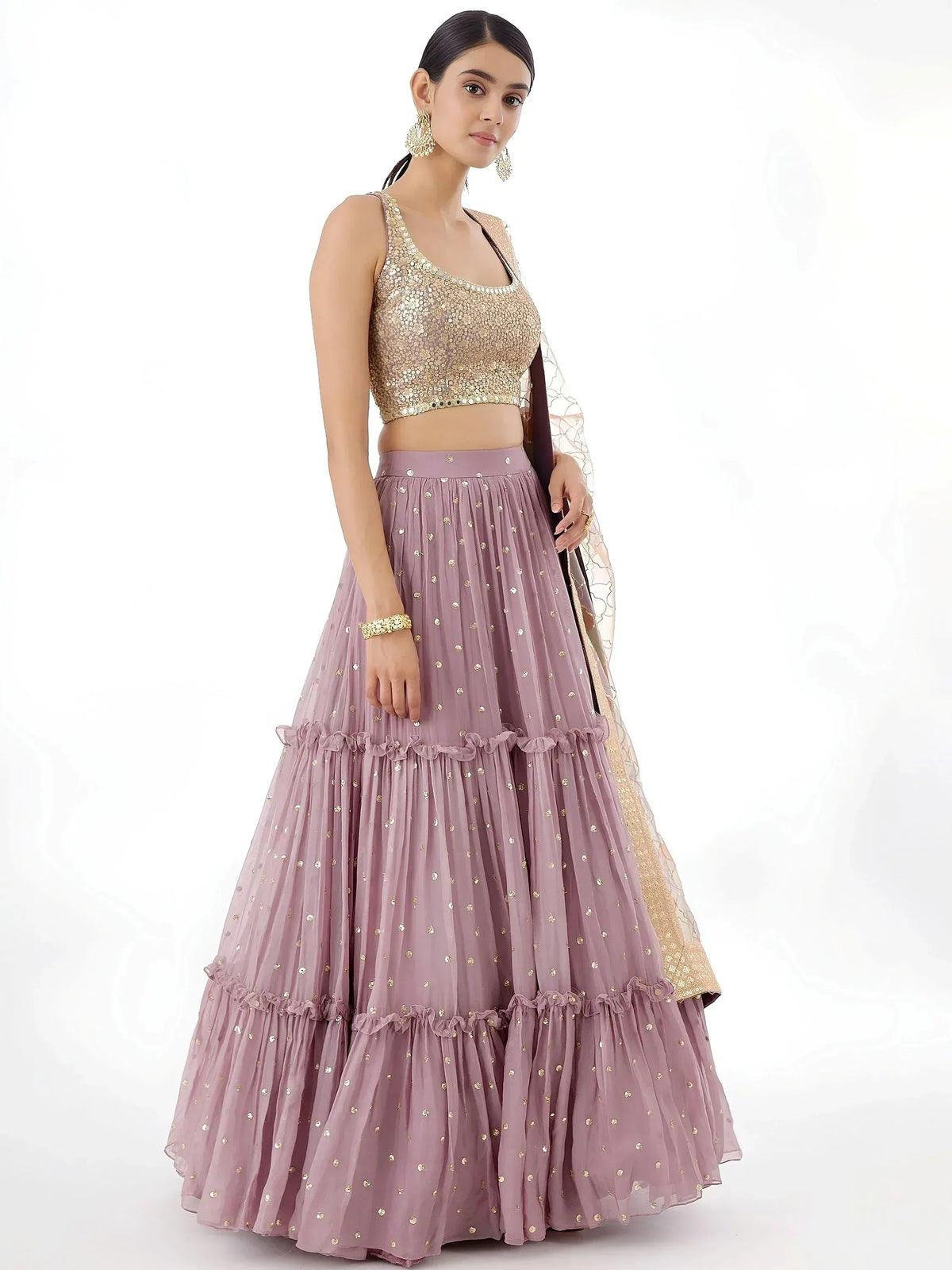 Dusty pink lehenga choli with gold sequin top and tiered skirt, perfect for Indian ethnic occasions