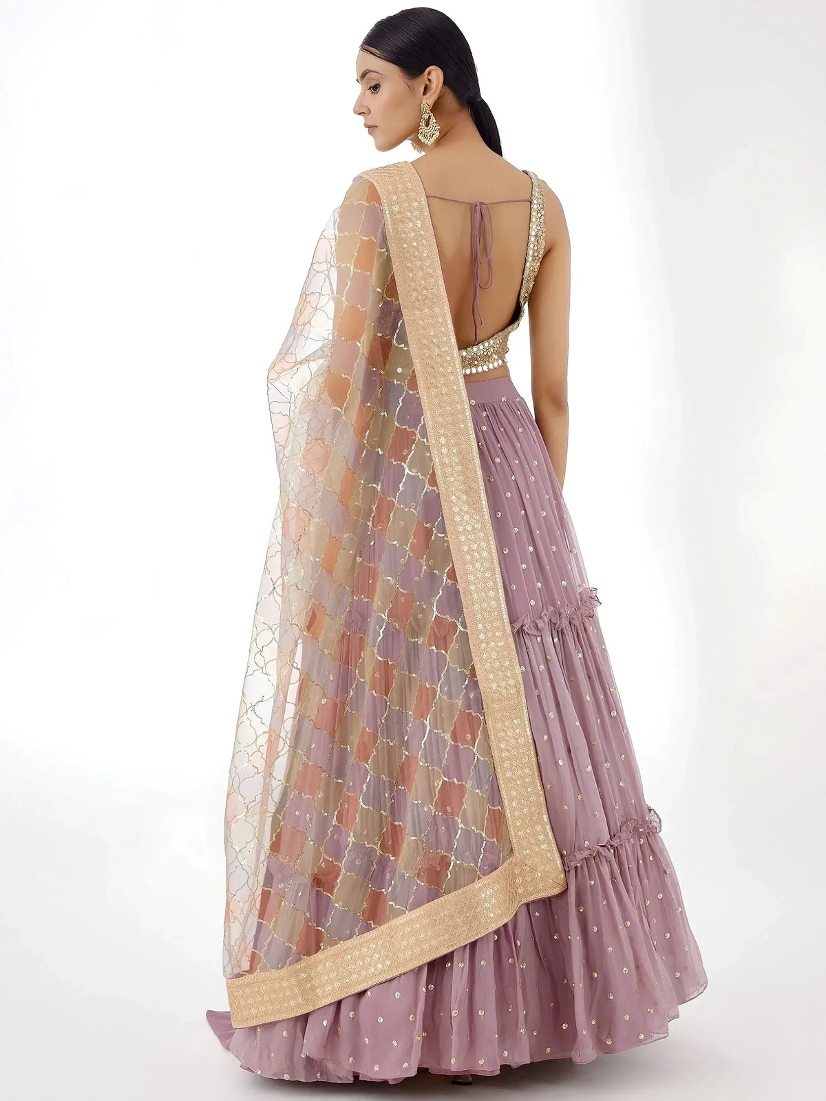 Elegant mauve lehenga choli with gold embroidery and sheer dupatta, perfect for Indian ethnic occasions