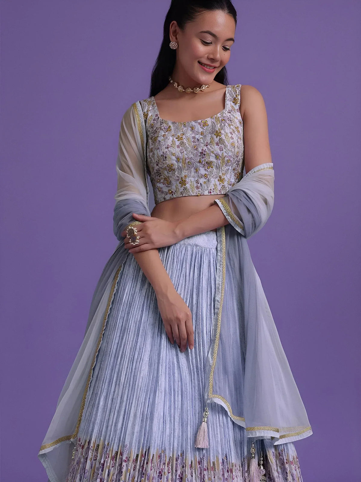 Light blue embroidered lehenga choli with floral blouse and sheer dupatta, perfect for Indian ethnic occasions.