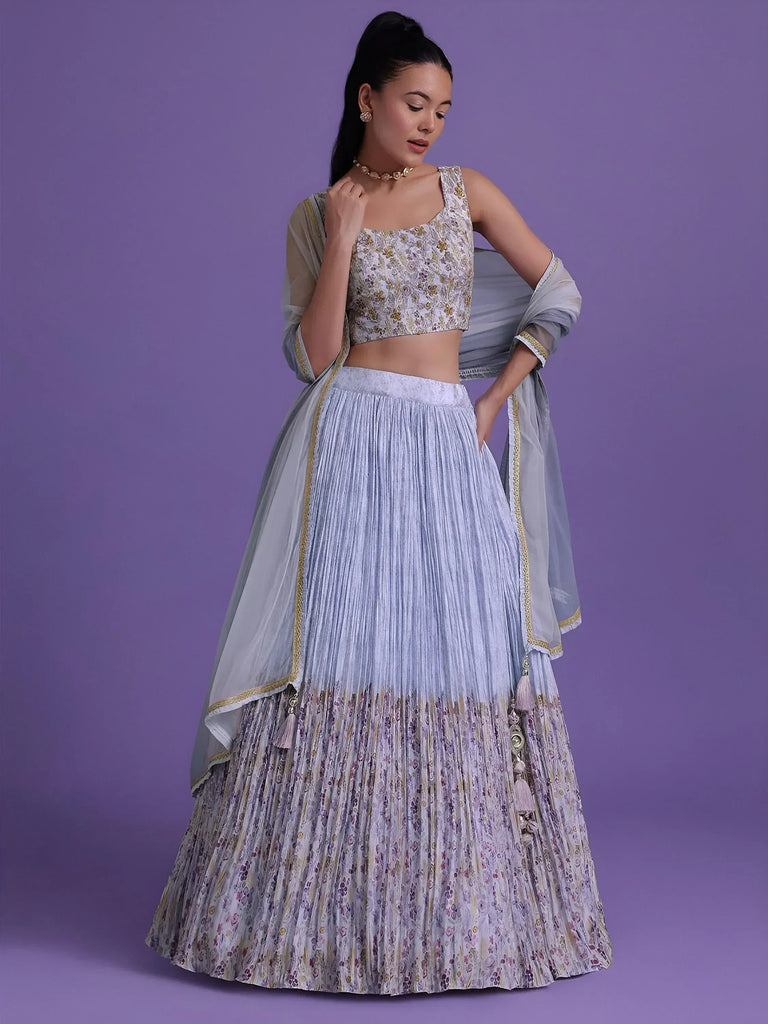 Elegant light blue pleated lehenga choli with floral print and gold trim, perfect for Indian ethnic occasions.