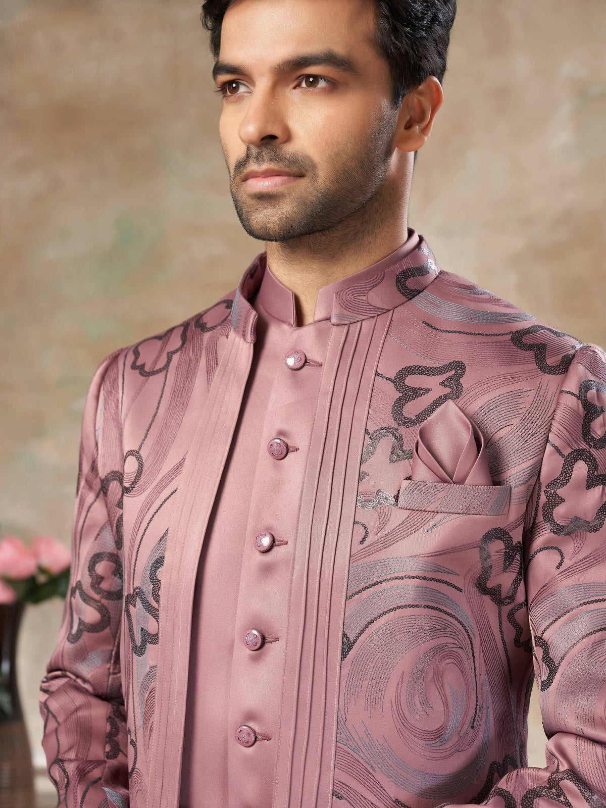 Pink designer sherwani with intricate black and silver embroidery, perfect for Indian ethnic wear occasions.