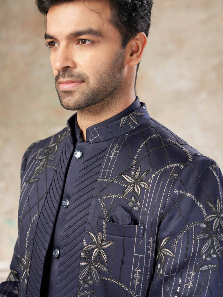Navy blue embroidered men's sherwani with floral motifs and geometric patterns, perfect for Indian ethnic occasions.