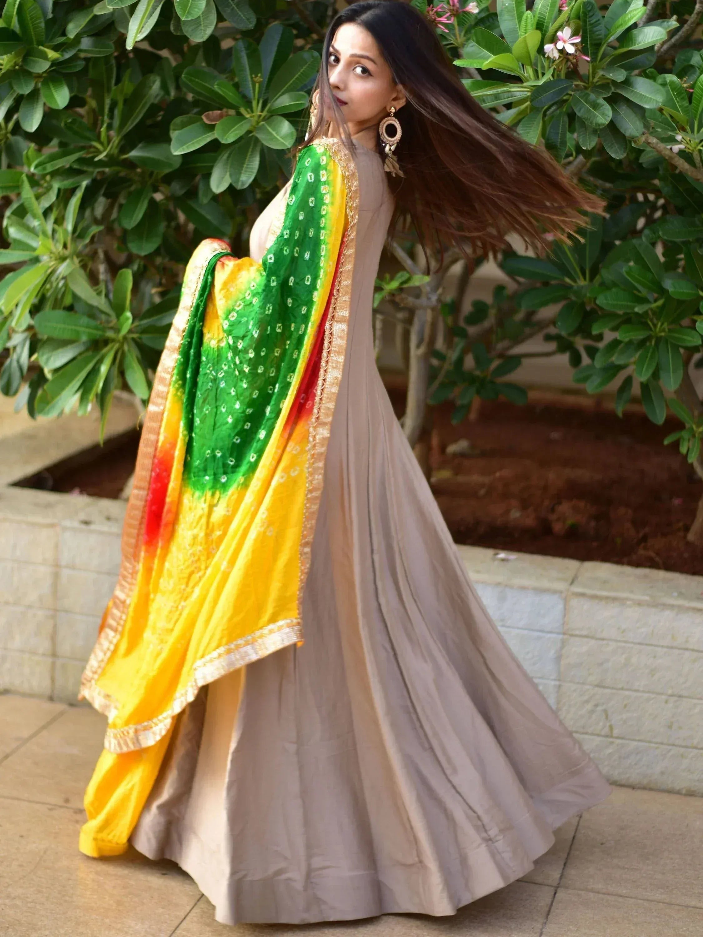 Elegant beige anarkali with vibrant green and yellow dupatta, perfect for Indian ethnic wear.