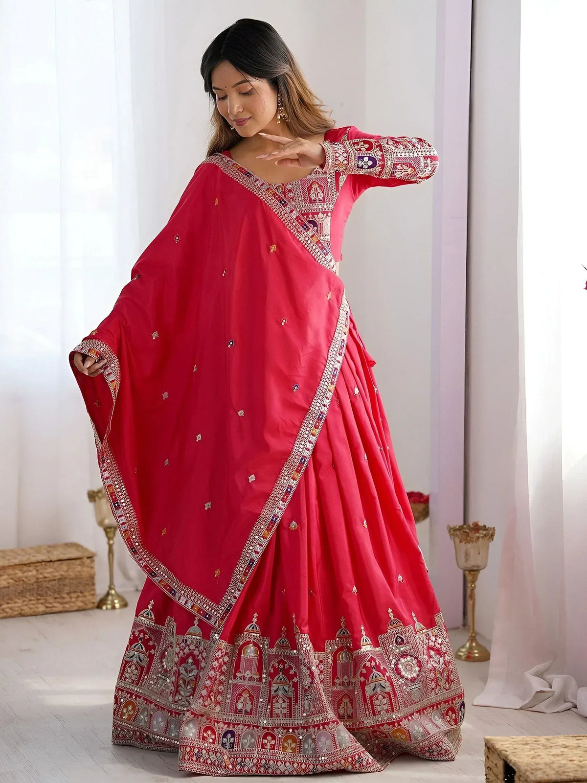 Red designer lehenga choli with intricate embroidery and mirror work, perfect for Indian ethnic wear occasions.