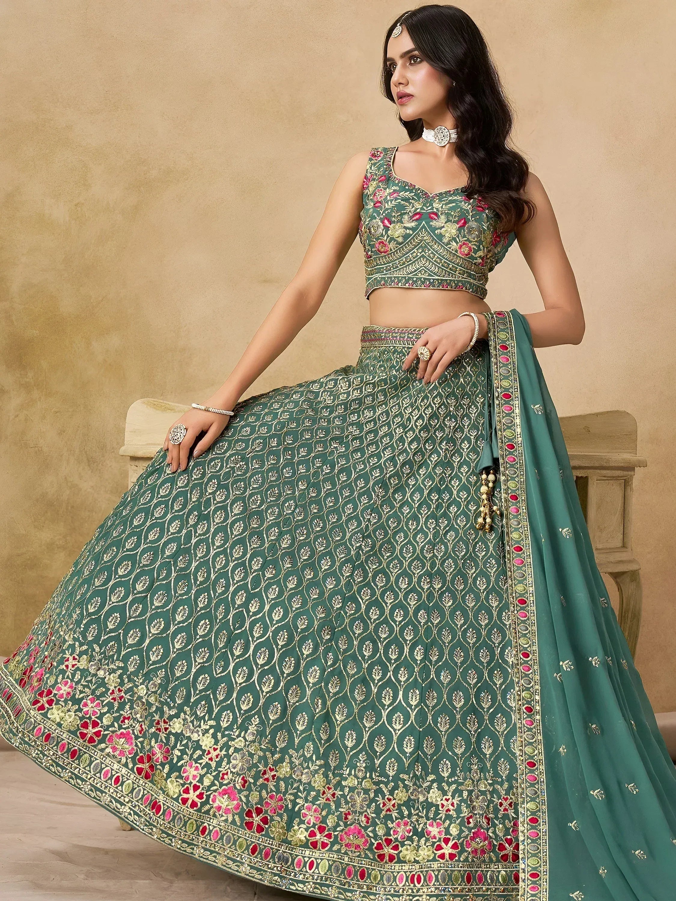 Green embroidered lehenga choli with floral gold detailing, perfect for Indian weddings and festive occasions
