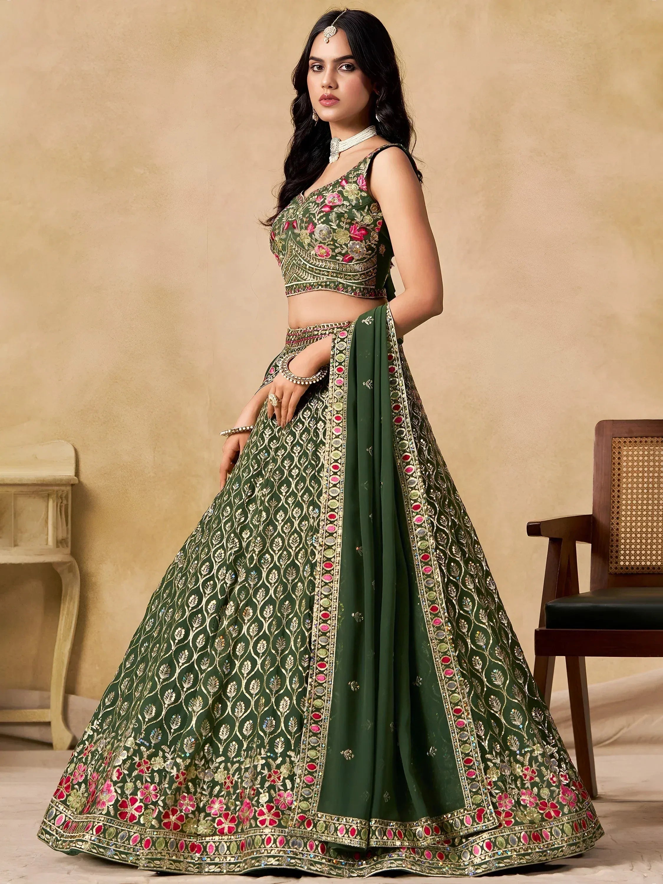 Green embroidered lehenga choli with floral motifs and gold detailing, perfect for Indian weddings and festive occasions.