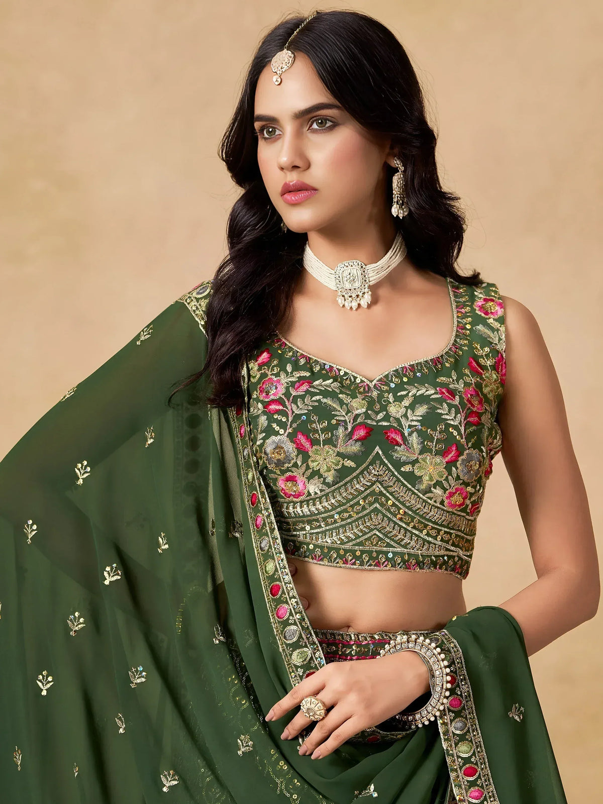 Green embroidered lehenga choli with floral motifs and matching dupatta, perfect for Indian ethnic wear.