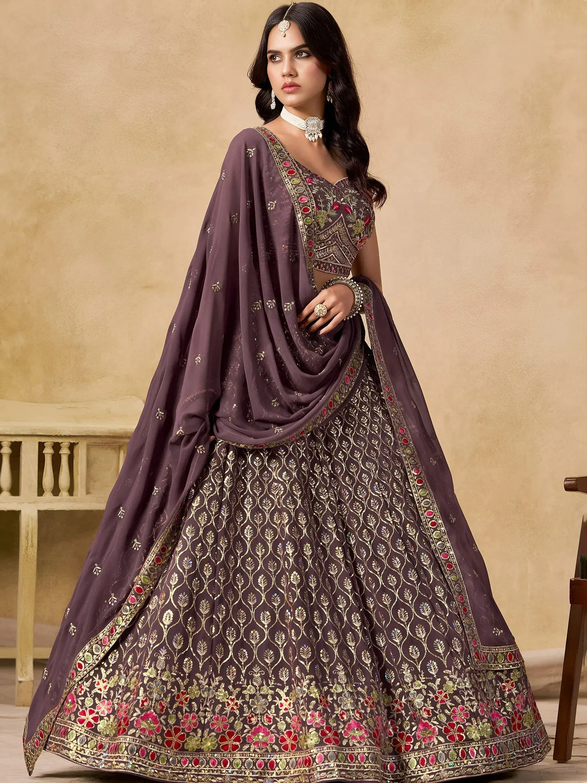 Elegant purple lehenga choli with gold embroidery and floral motifs, perfect for Indian ethnic wear occasions.