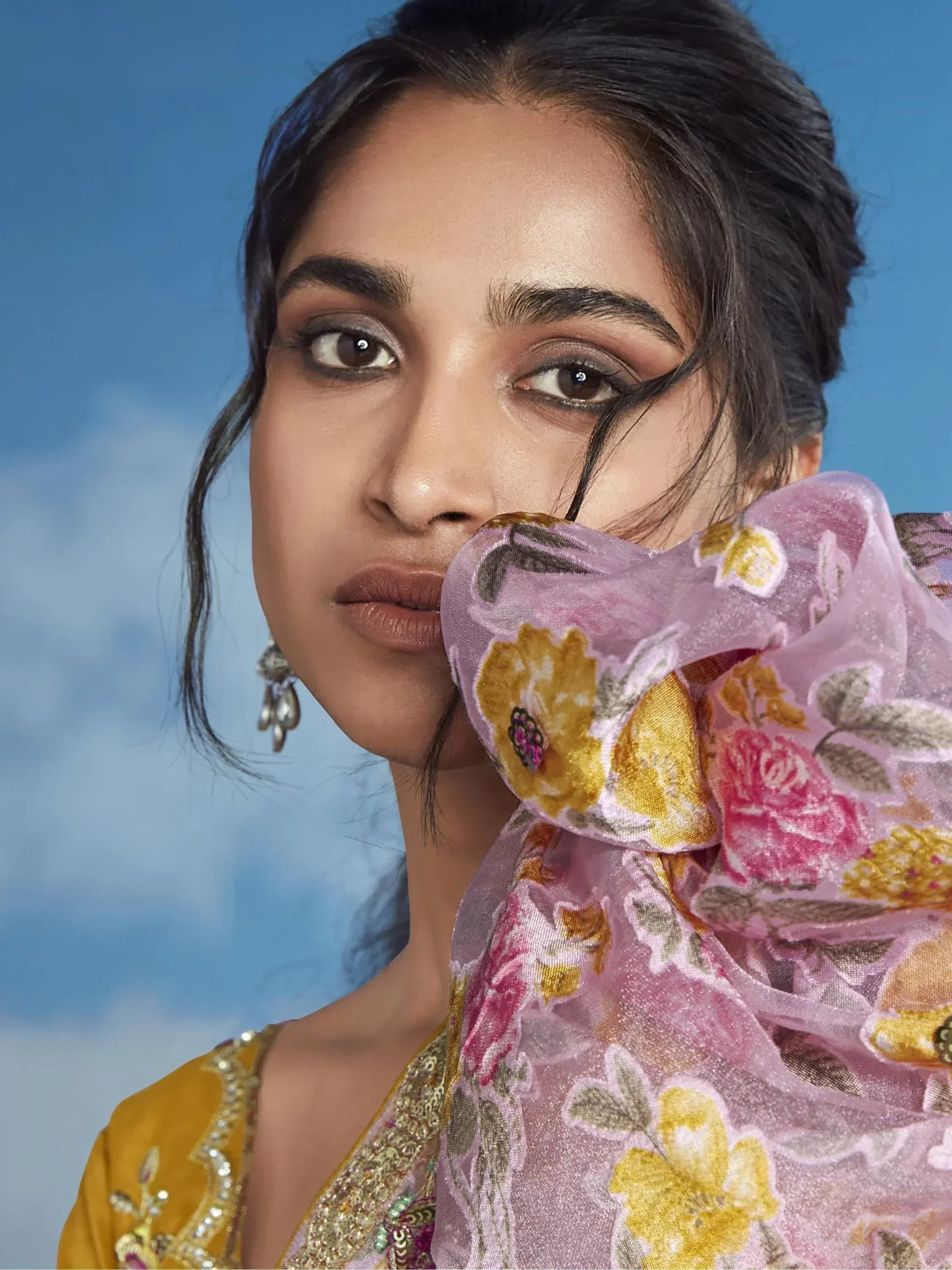 Woman in floral dupatta and embroidered yellow ethnic wear, perfect for Indian occasions