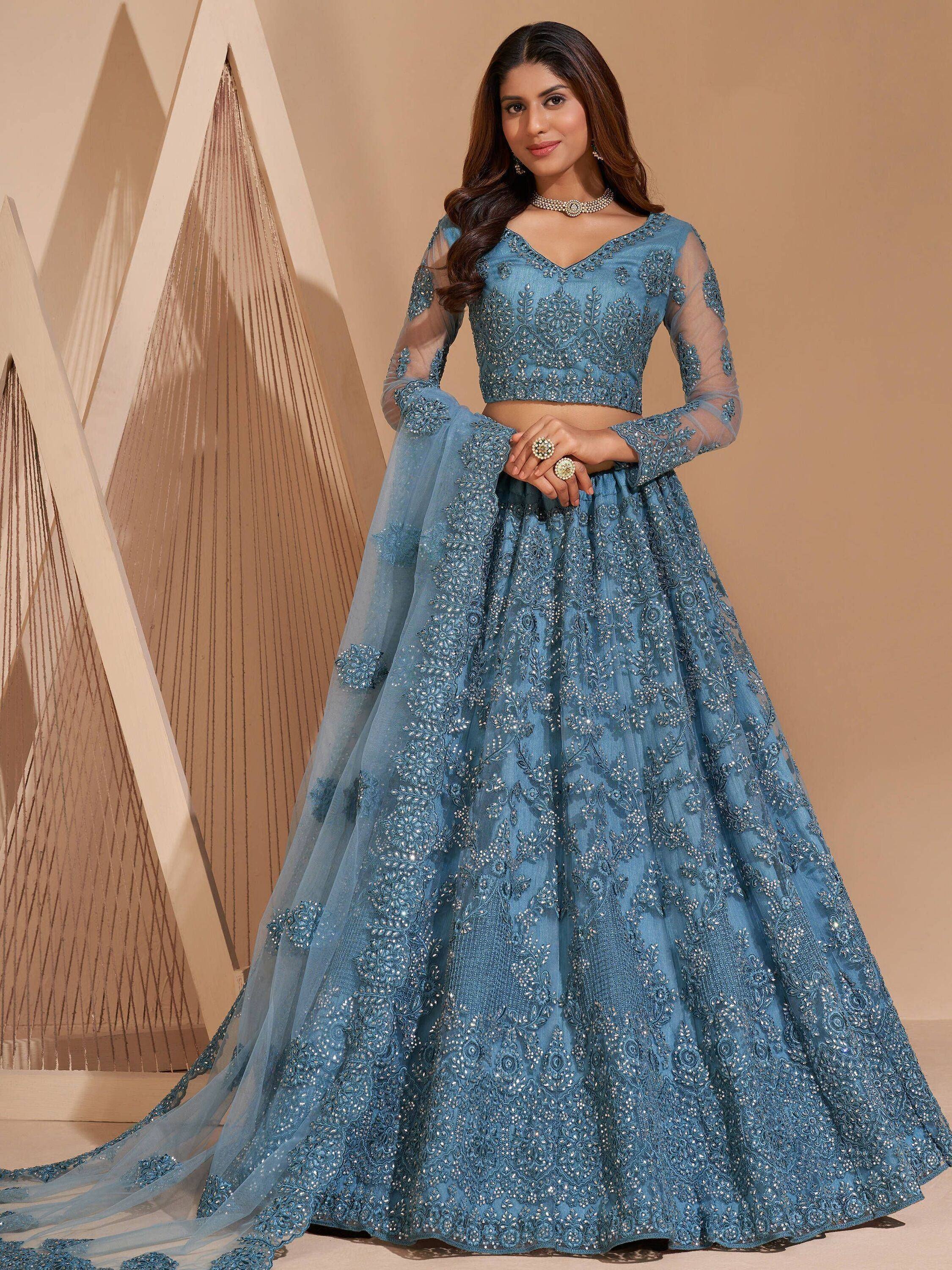 Blue embroidered lehenga choli with sheer sleeves, perfect for Indian weddings and festive occasions.