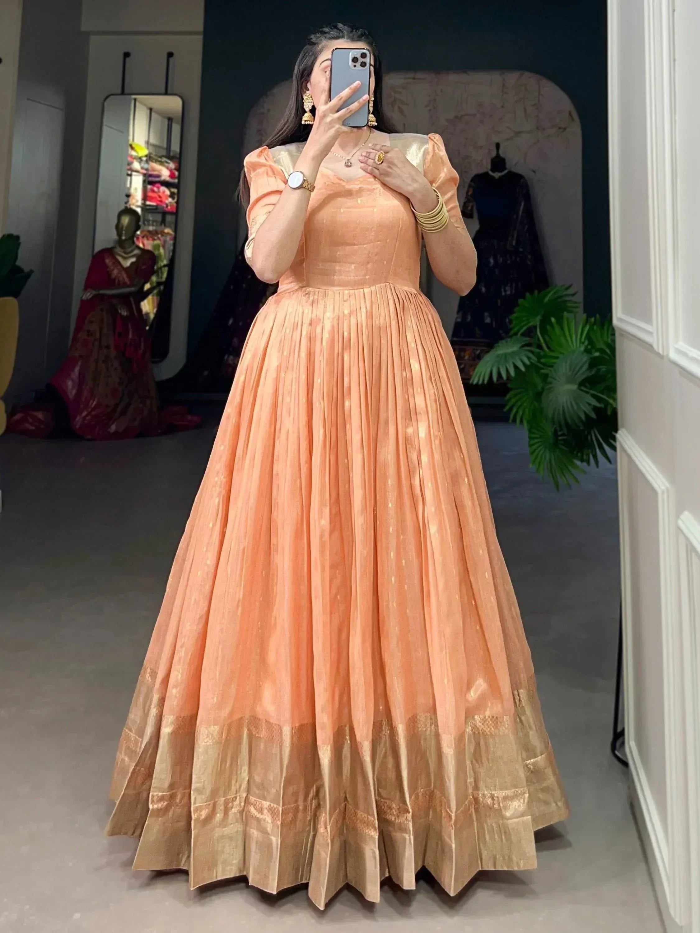 Peach ethnic gown with gold trim, pleated skirt, puff sleeves for Indian occasions