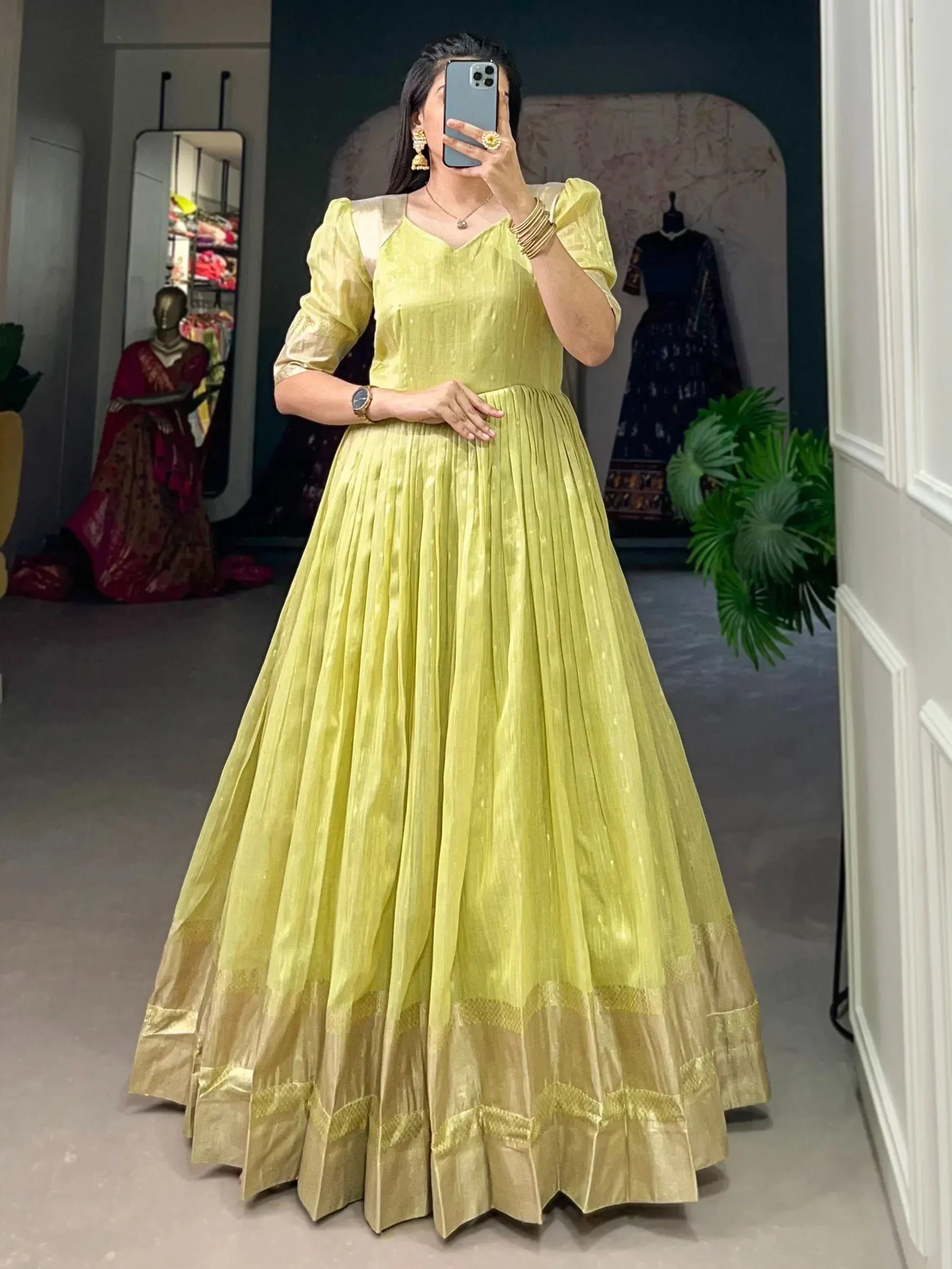 Lemon green ethnic gown with puff sleeves and pleated skirt, perfect for Indian occasions