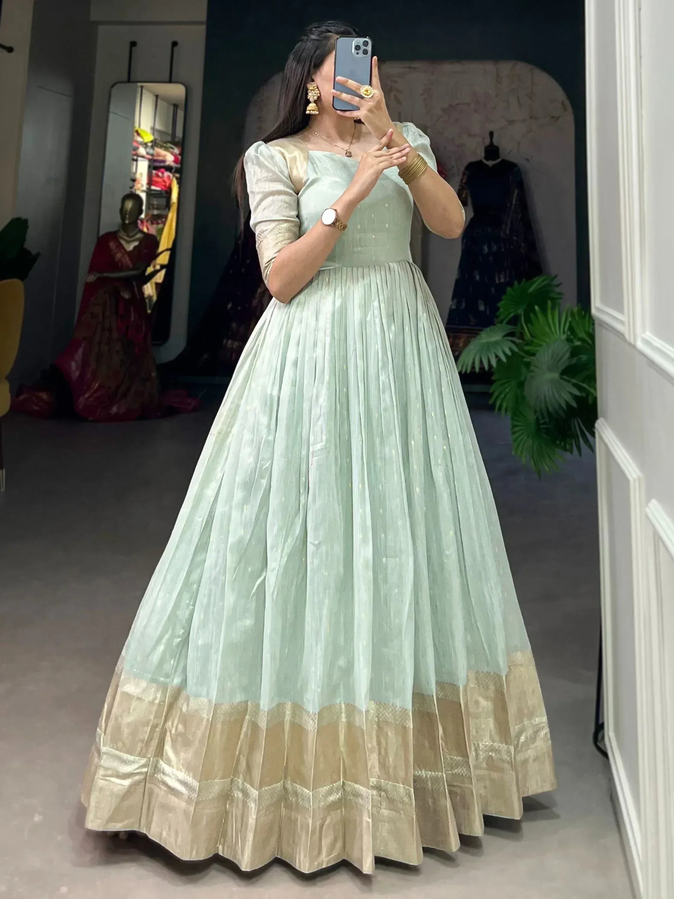 Mint green ethnic gown with gold border, perfect for Indian weddings and festive occasions