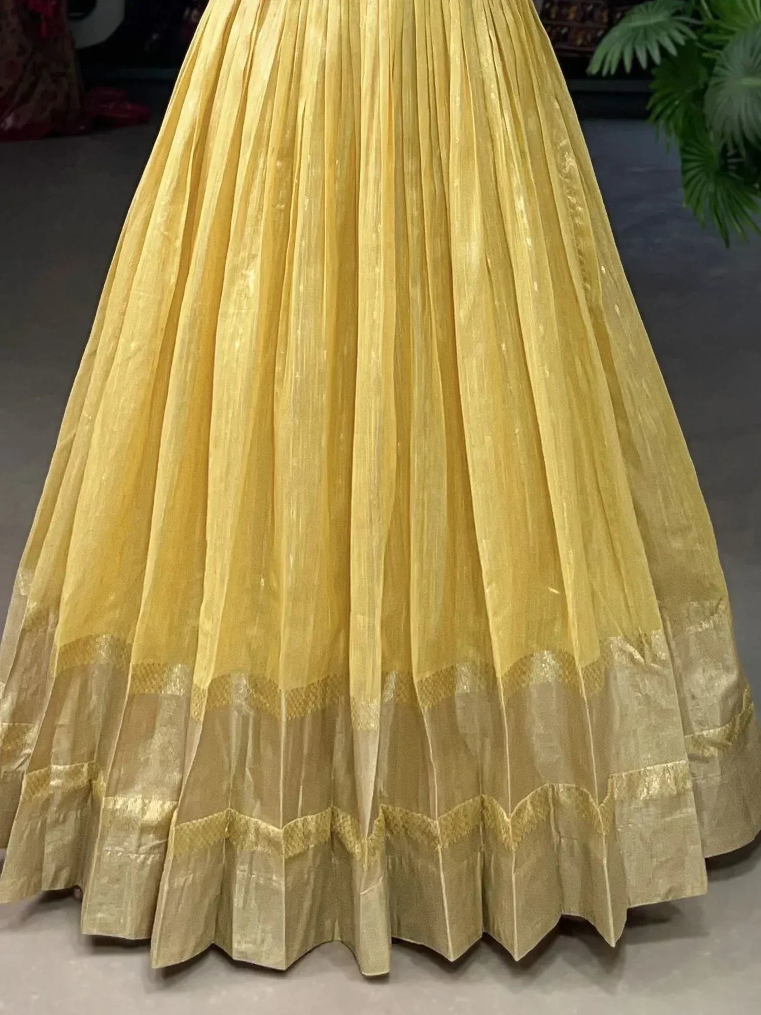 Yellow pleated lehenga skirt with golden border, ethnic wear for Indian occasions