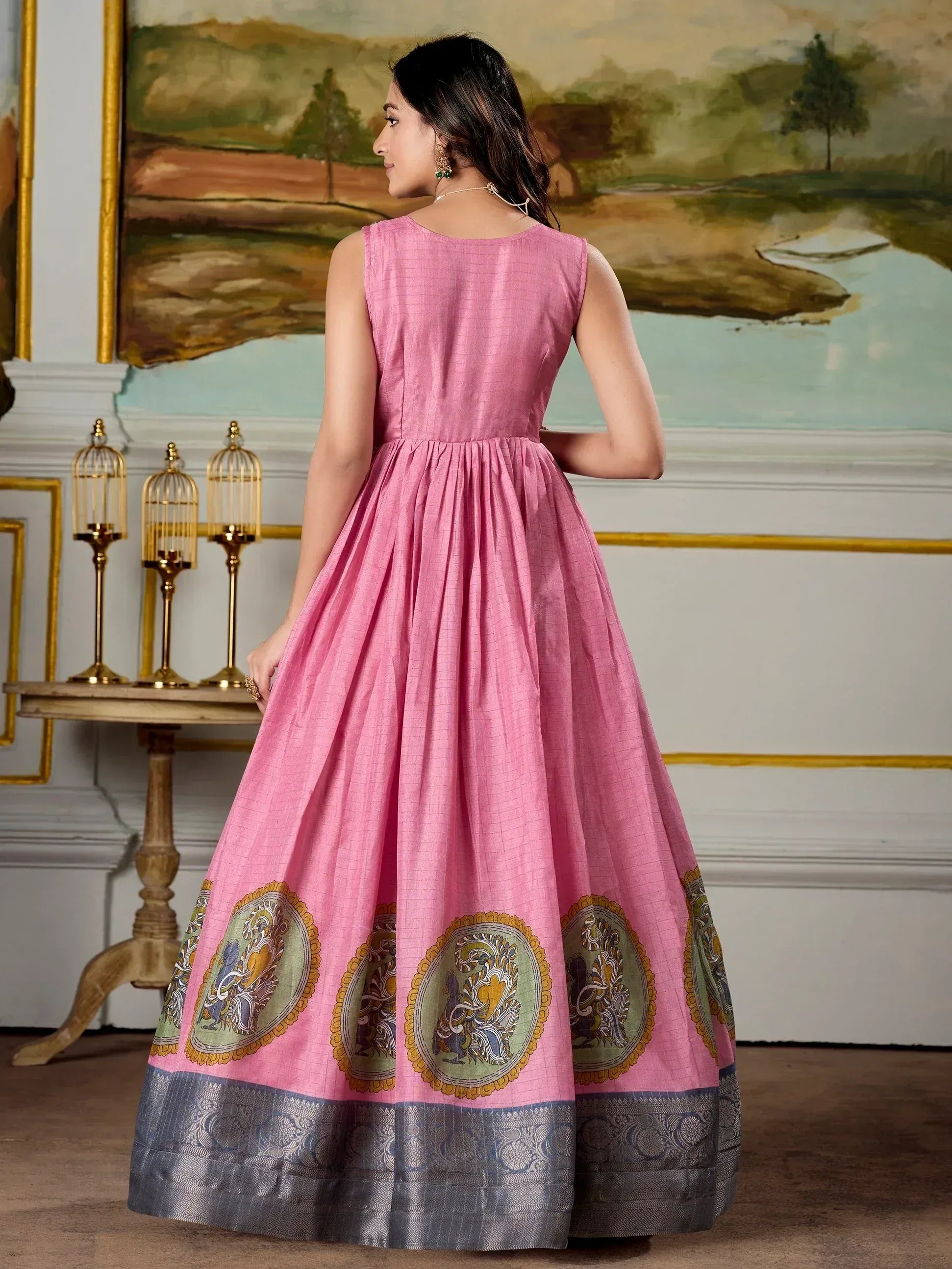 Pink ethnic gown with printed motifs and woven border, perfect for festive occasions