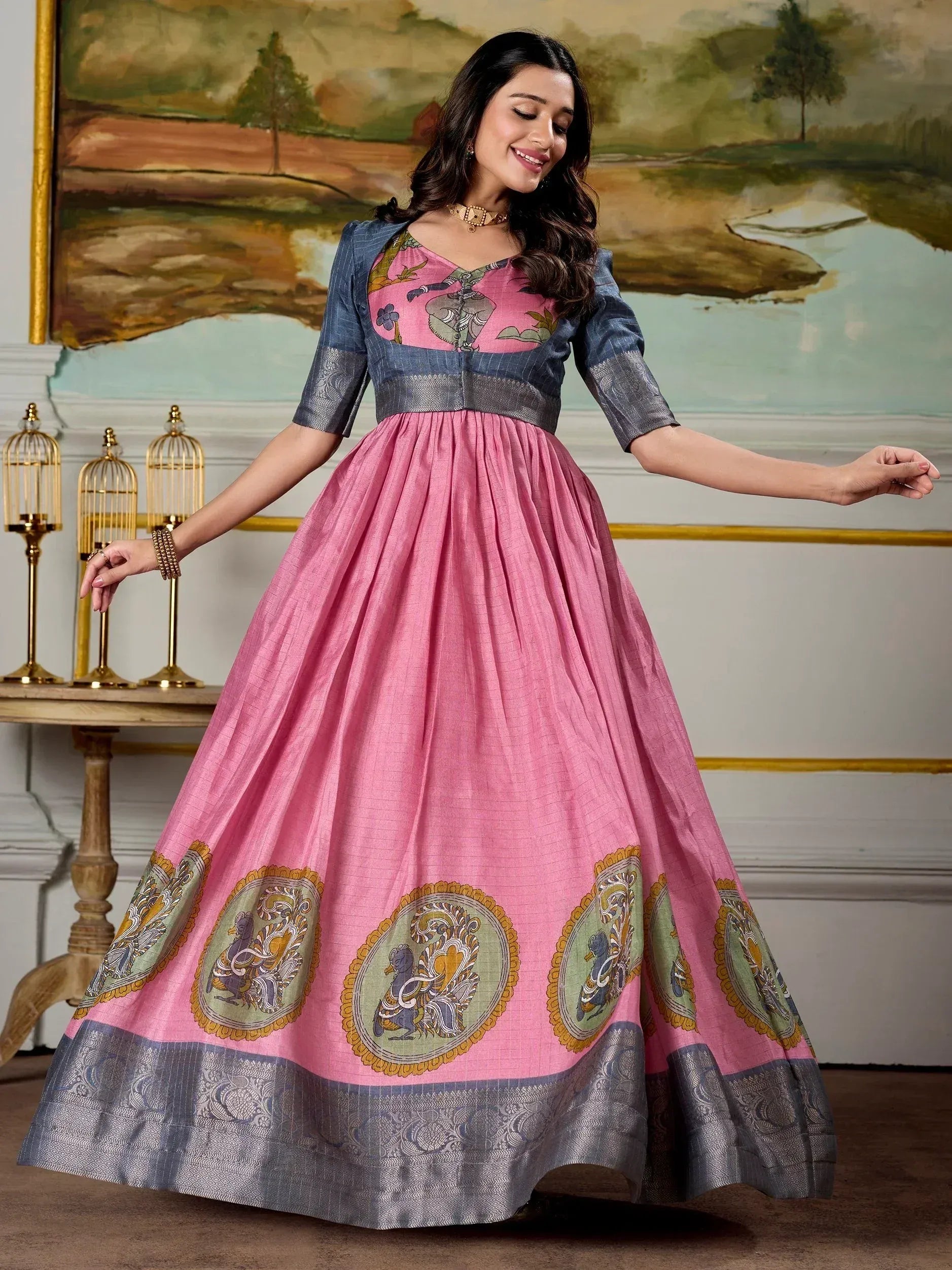 Pink ethnic gown with blue sleeves and peacock motifs, perfect for Indian festive wear