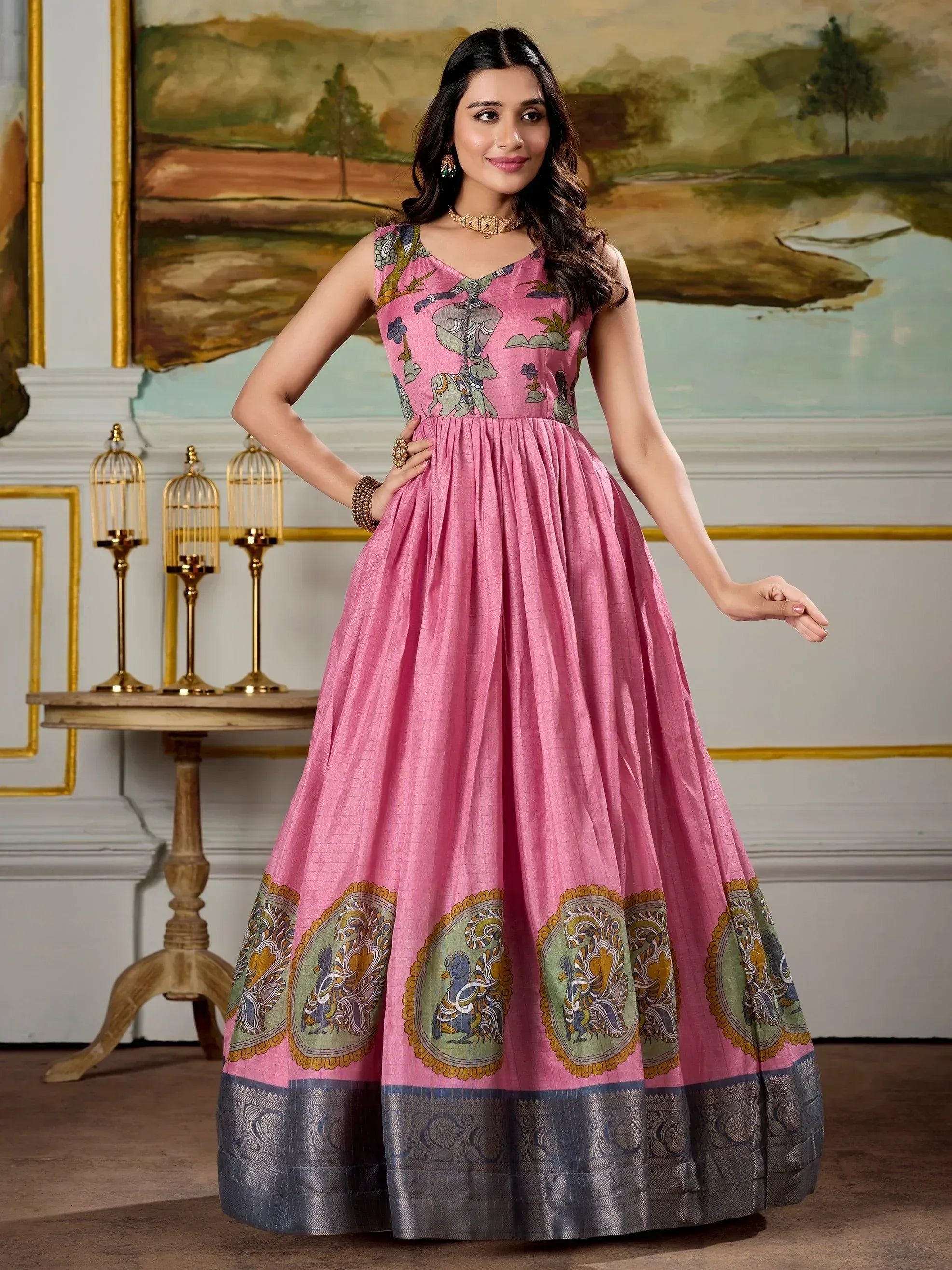 Pink ethnic gown with elephant print and paisley border, perfect for Indian occasions