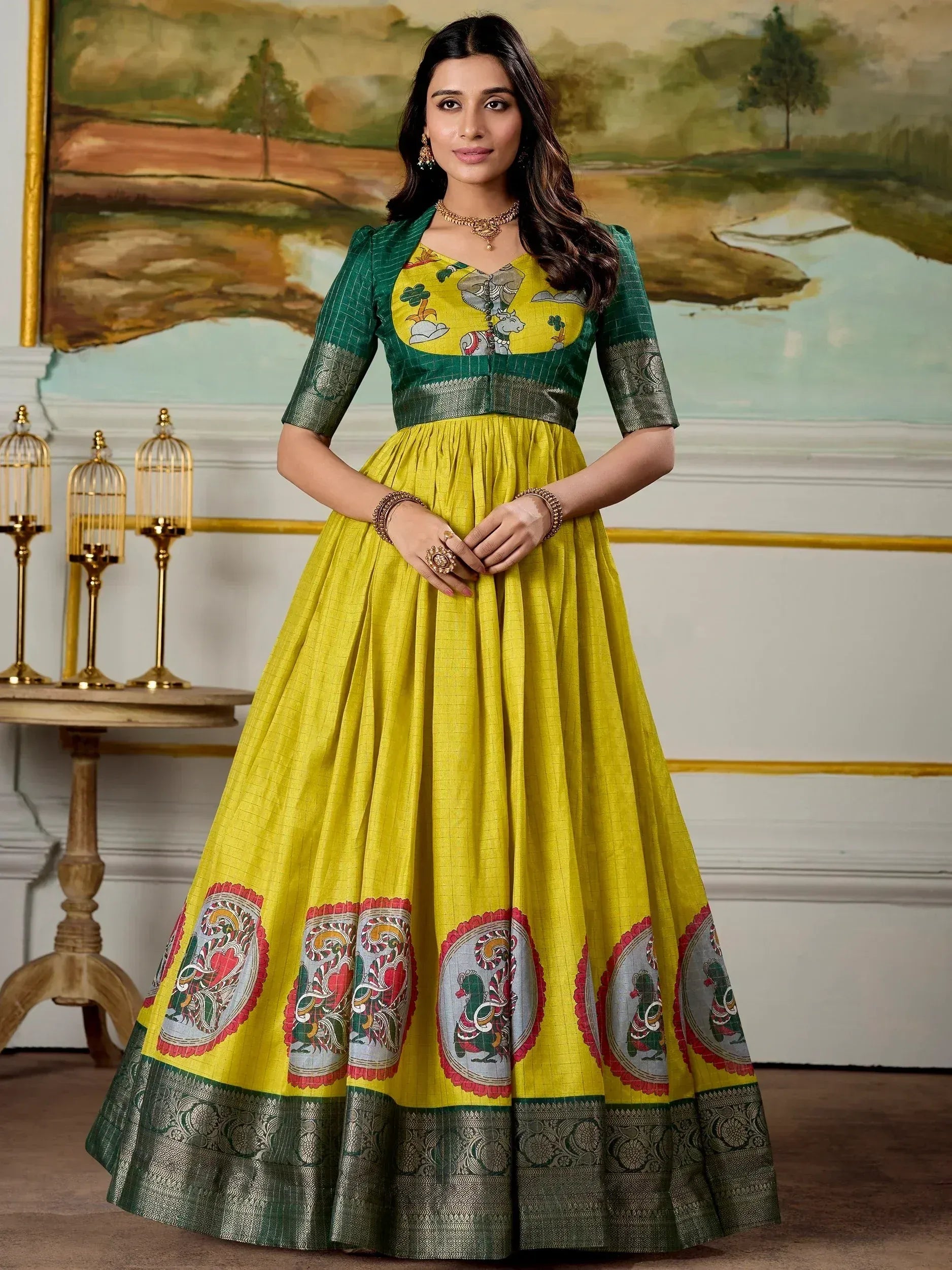 Yellow and green Indian ethnic gown with elephant print and paisley border, perfect for festive occasions.