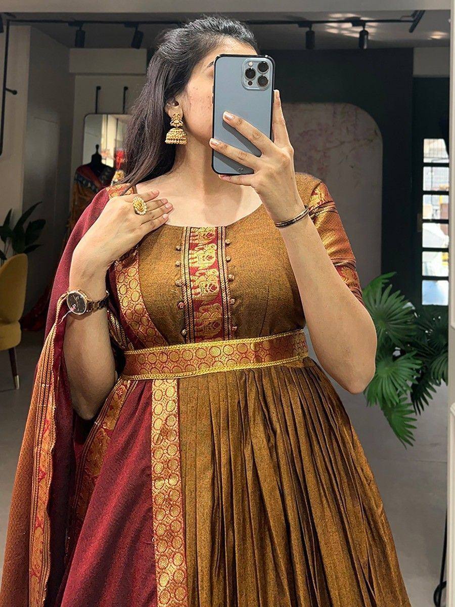 Woman in golden ethnic gown with red dupatta, taking mirror selfie, traditional Indian wear