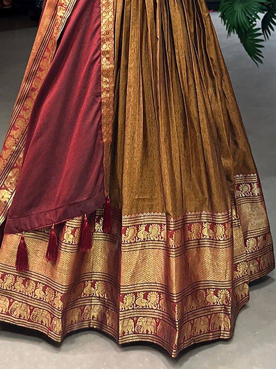 Gold and maroon ethnic lehenga with elephant motifs and tassels, perfect for Indian weddings and festivals