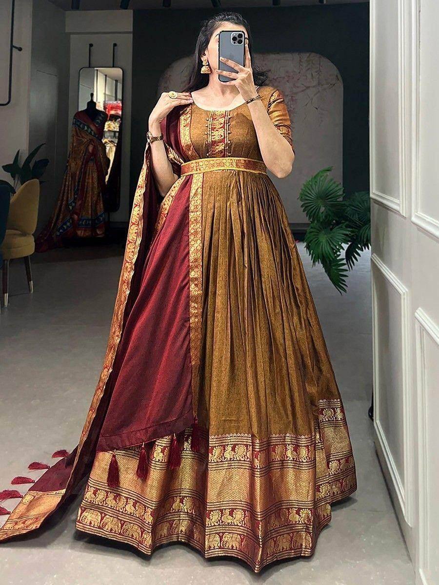 Woman wearing maroon and gold ethnic lehenga choli with elephant print border, perfect for Indian weddings or festivals