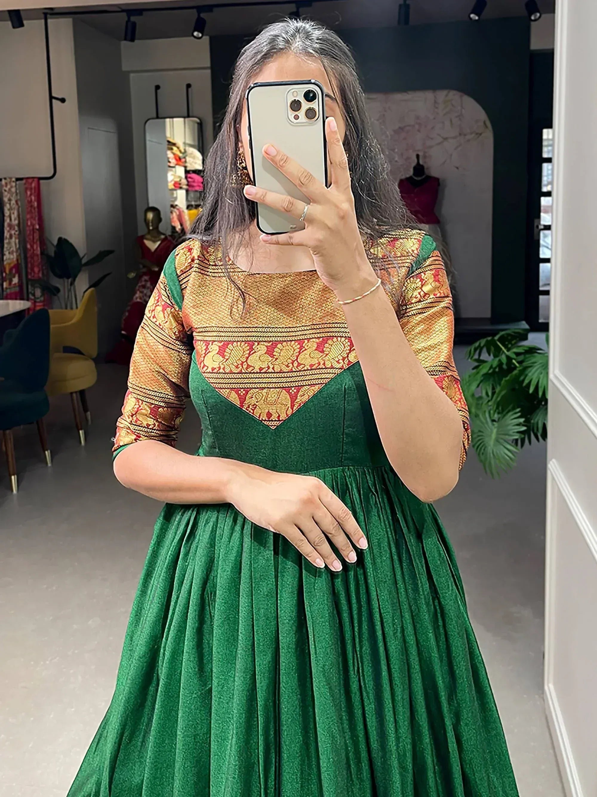 Green ethnic gown with gold and red brocade bodice, perfect for Indian festive occasions.