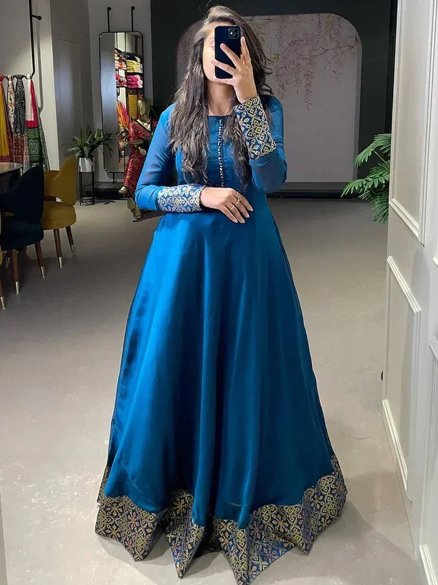 Blue ethnic gown with embroidered sleeves and border, perfect for Indian festive occasions