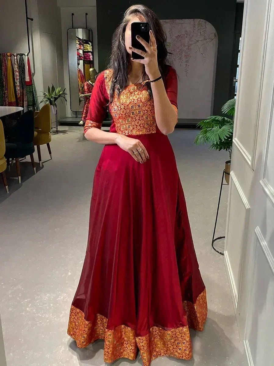 Woman in red ethnic gown with gold print, perfect for Indian occasions and festive wear