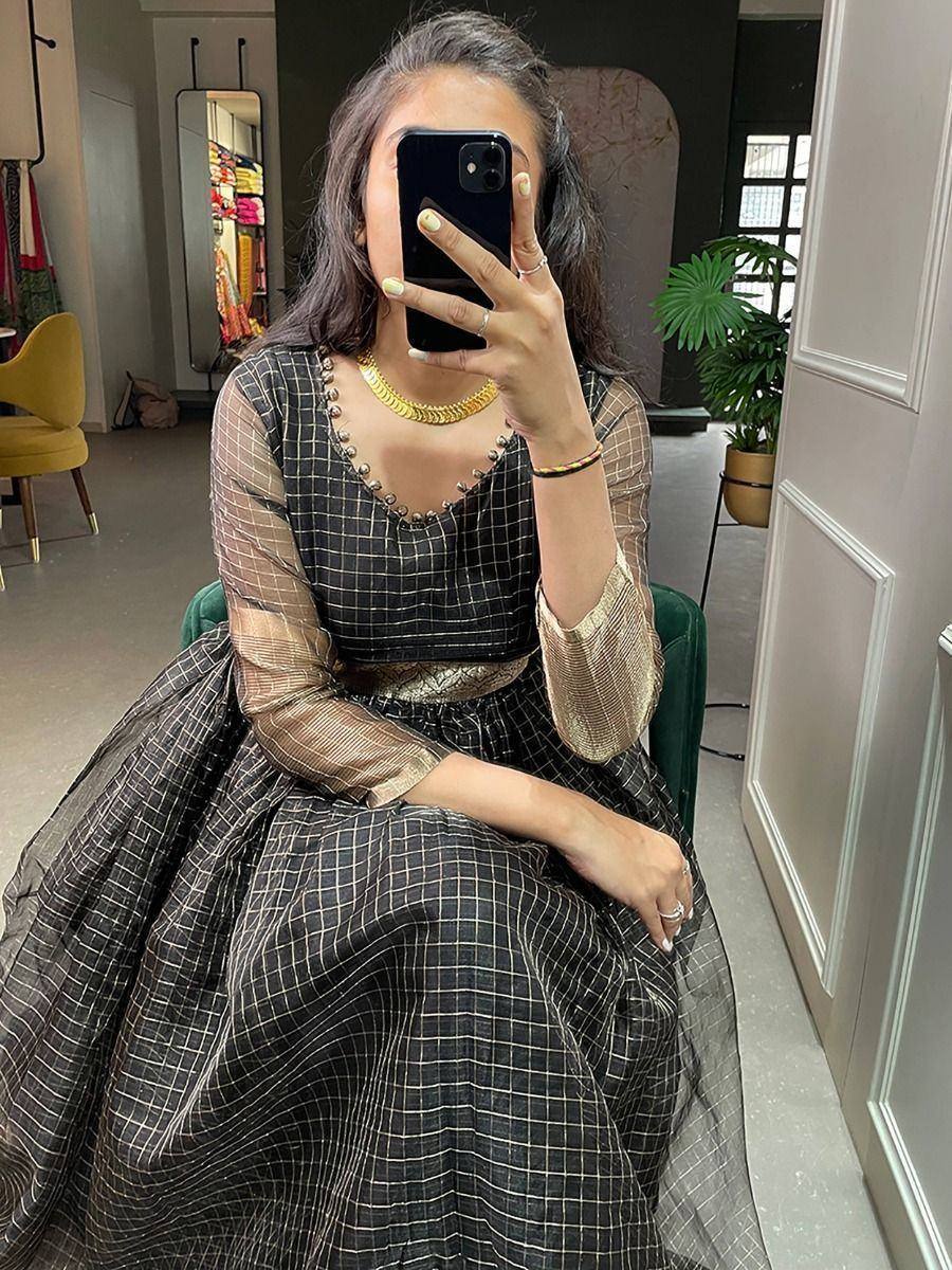 Elegant black and gold checkered ethnic gown with sheer sleeves and gold jewelry
