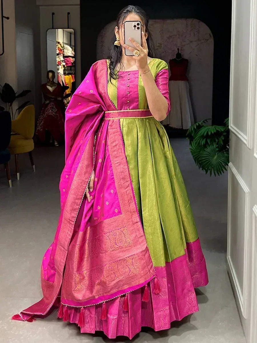 Woman wearing green and pink silk lehenga choli with gold embroidered dupatta