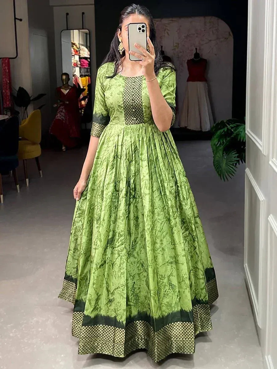 Green printed ethnic gown with net panel, perfect for Indian occasions and festive wear