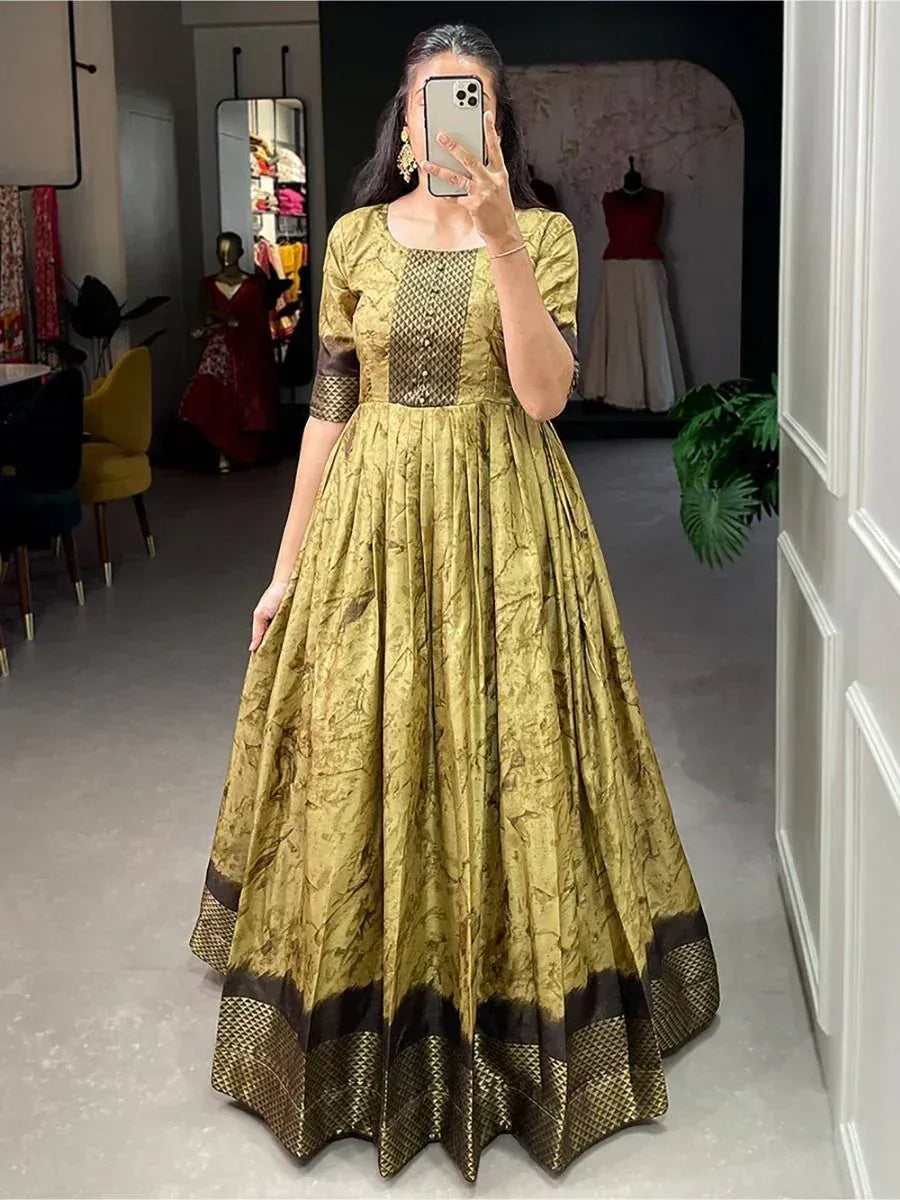 Woman wearing gold and brown ethnic gown with intricate patterns, perfect for Indian festive occasions