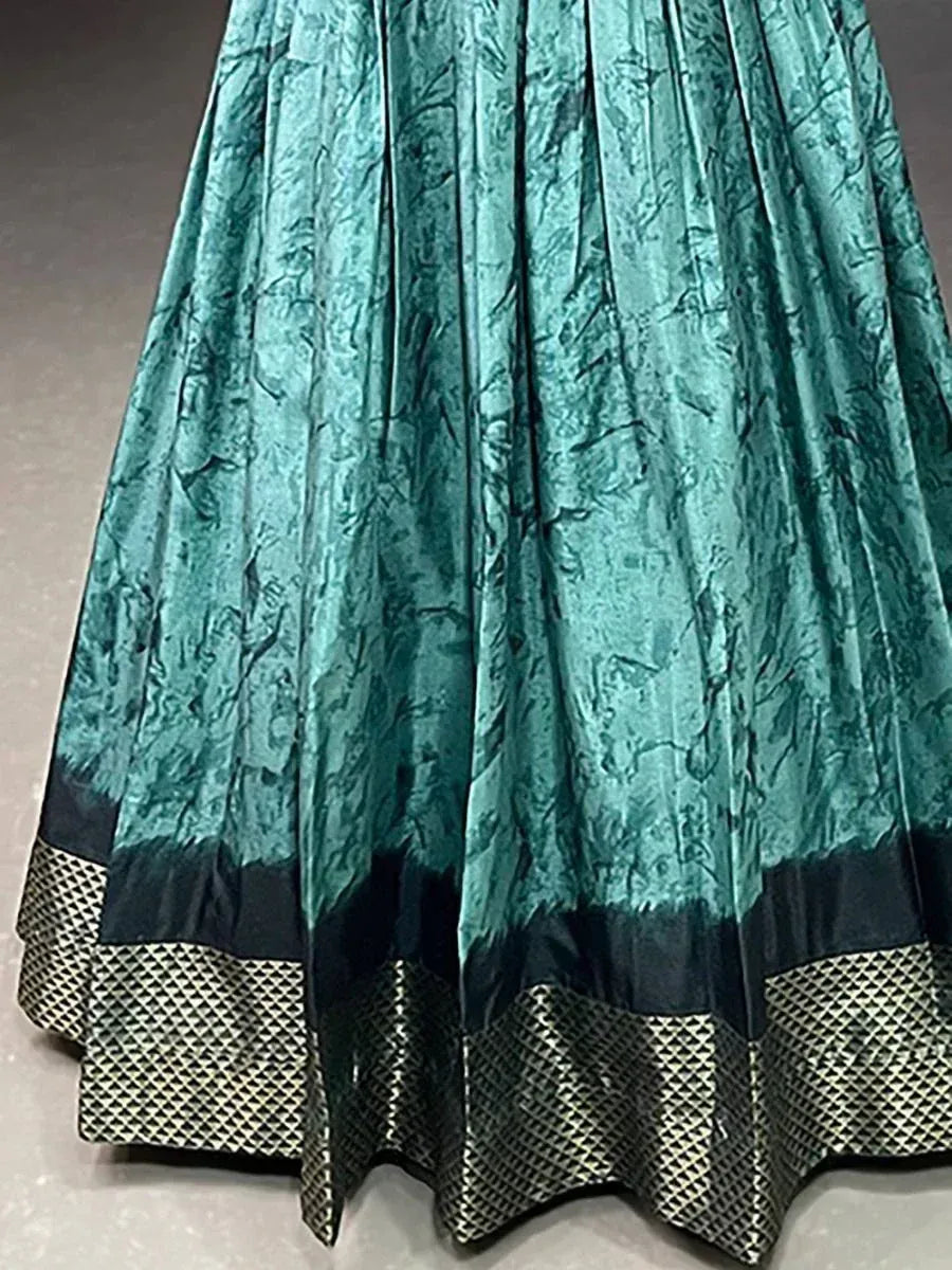 Teal green pleated lehenga skirt with black and gold geometric border, ethnic Indian wear