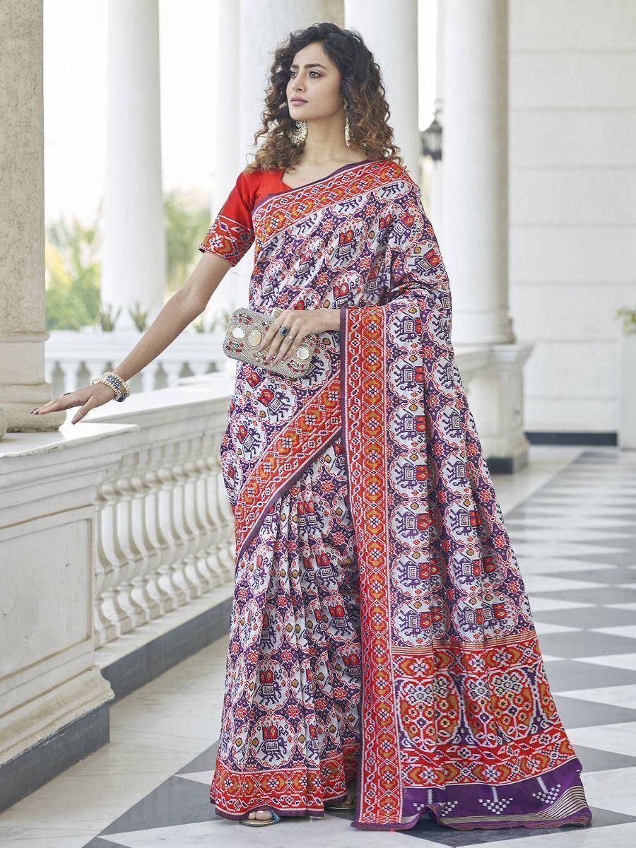 Woman in vibrant printed saree with red blouse, ethnic Indian wear for festive occasions