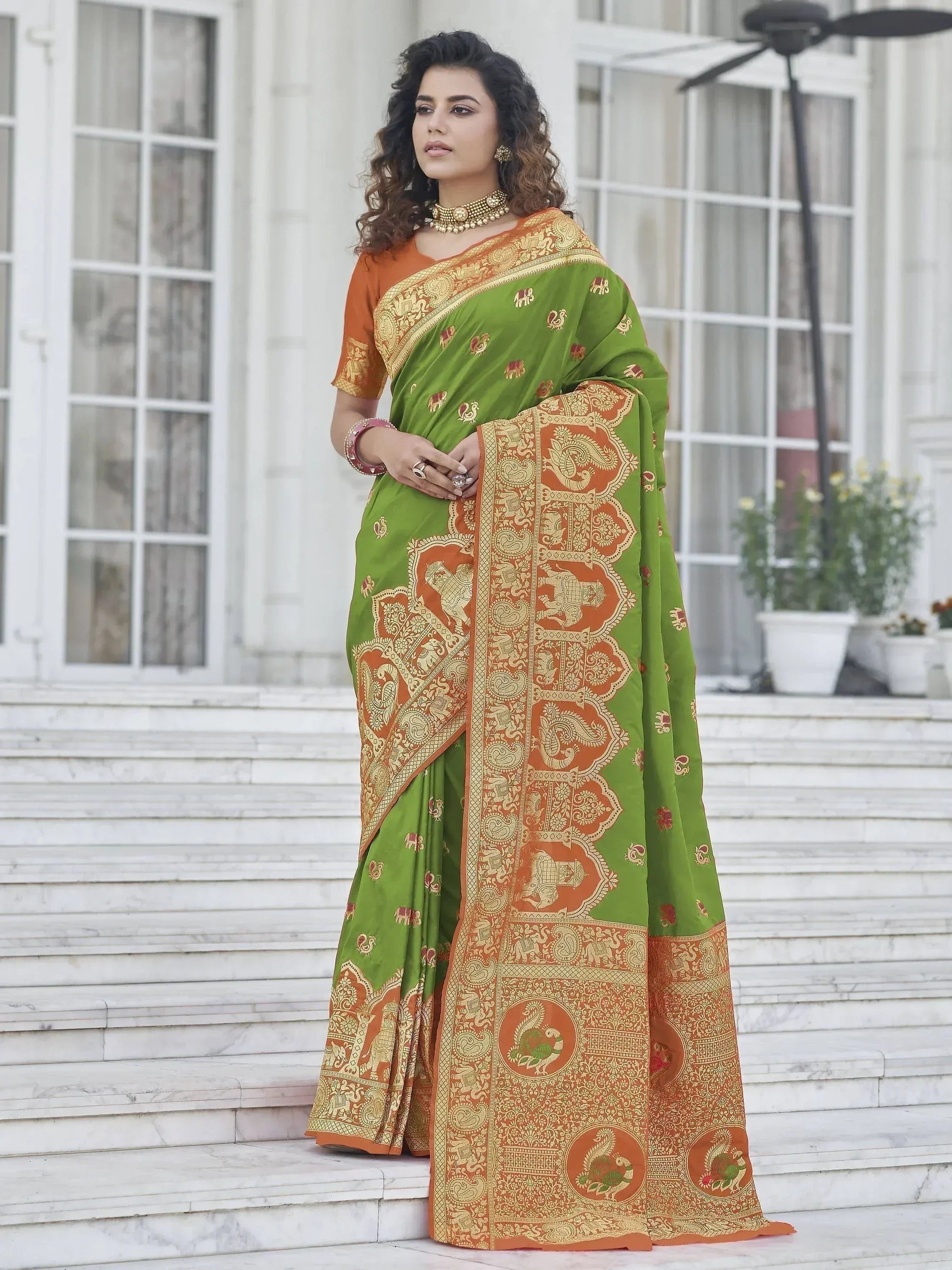 Green and orange designer saree with elephant and peacock motifs, perfect for Indian ethnic wear occasions