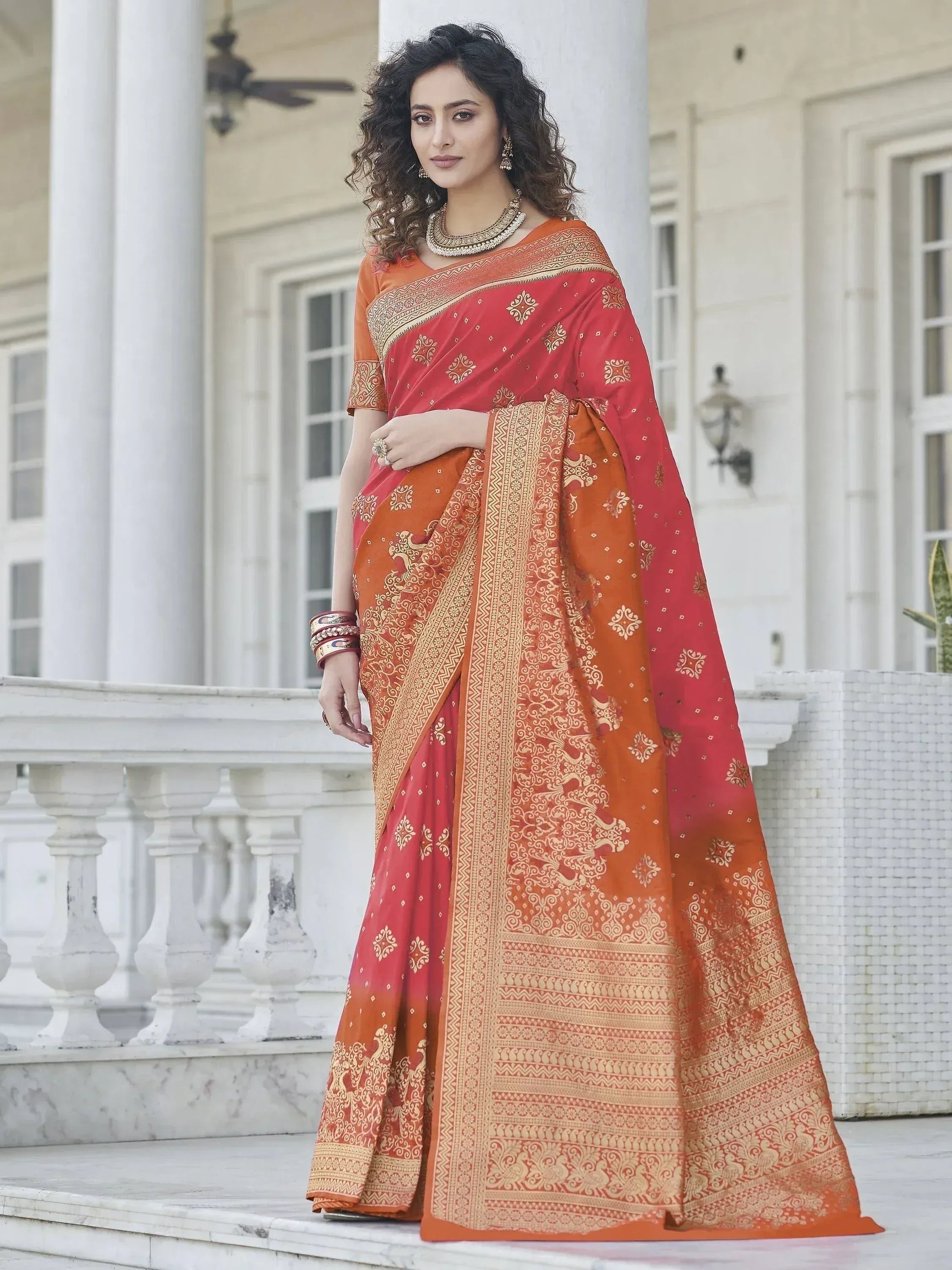 Elegant red and orange saree with gold embroidery, perfect for ethnic occasions.