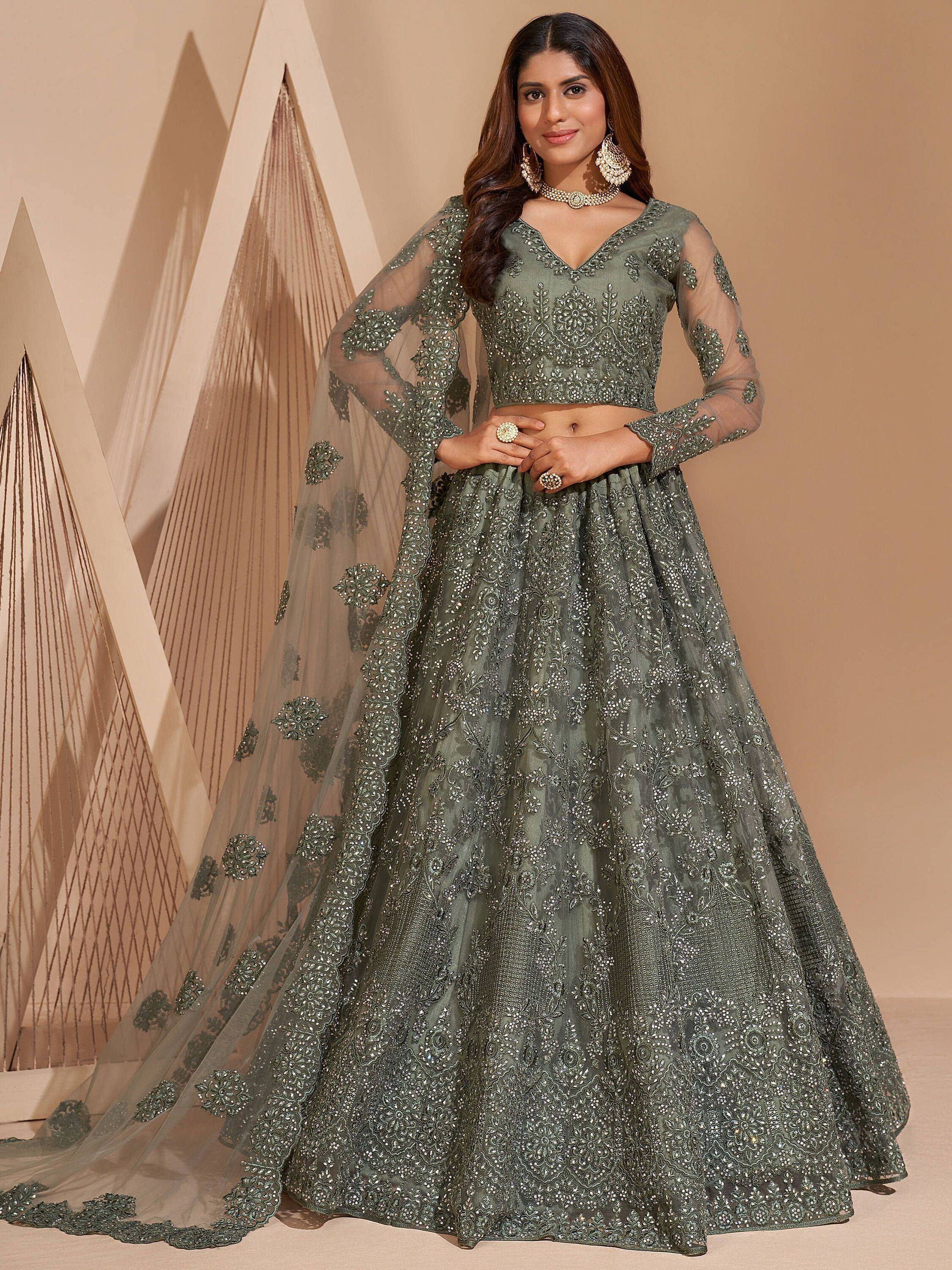 Olive green designer lehenga choli with heavy embroidery and sheer dupatta, perfect for Indian weddings and parties.