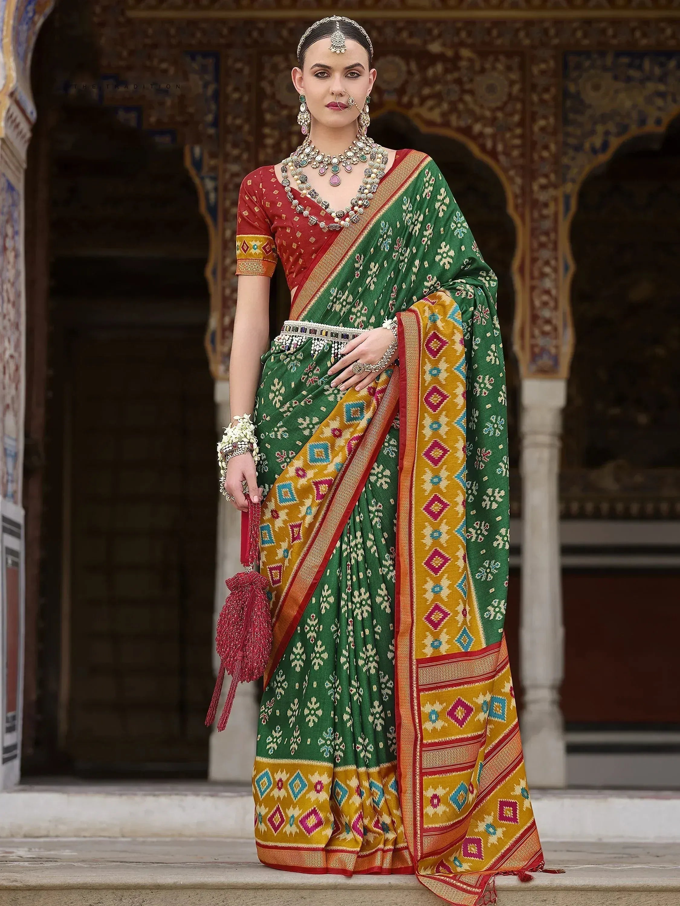 Green and yellow printed saree with red blouse, traditional Indian ethnic wear, temple backdrop