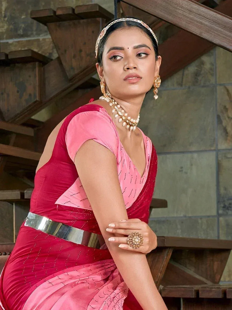 Woman in pink and red designer saree with pearl jewelry, ethnic wear for festive occasions