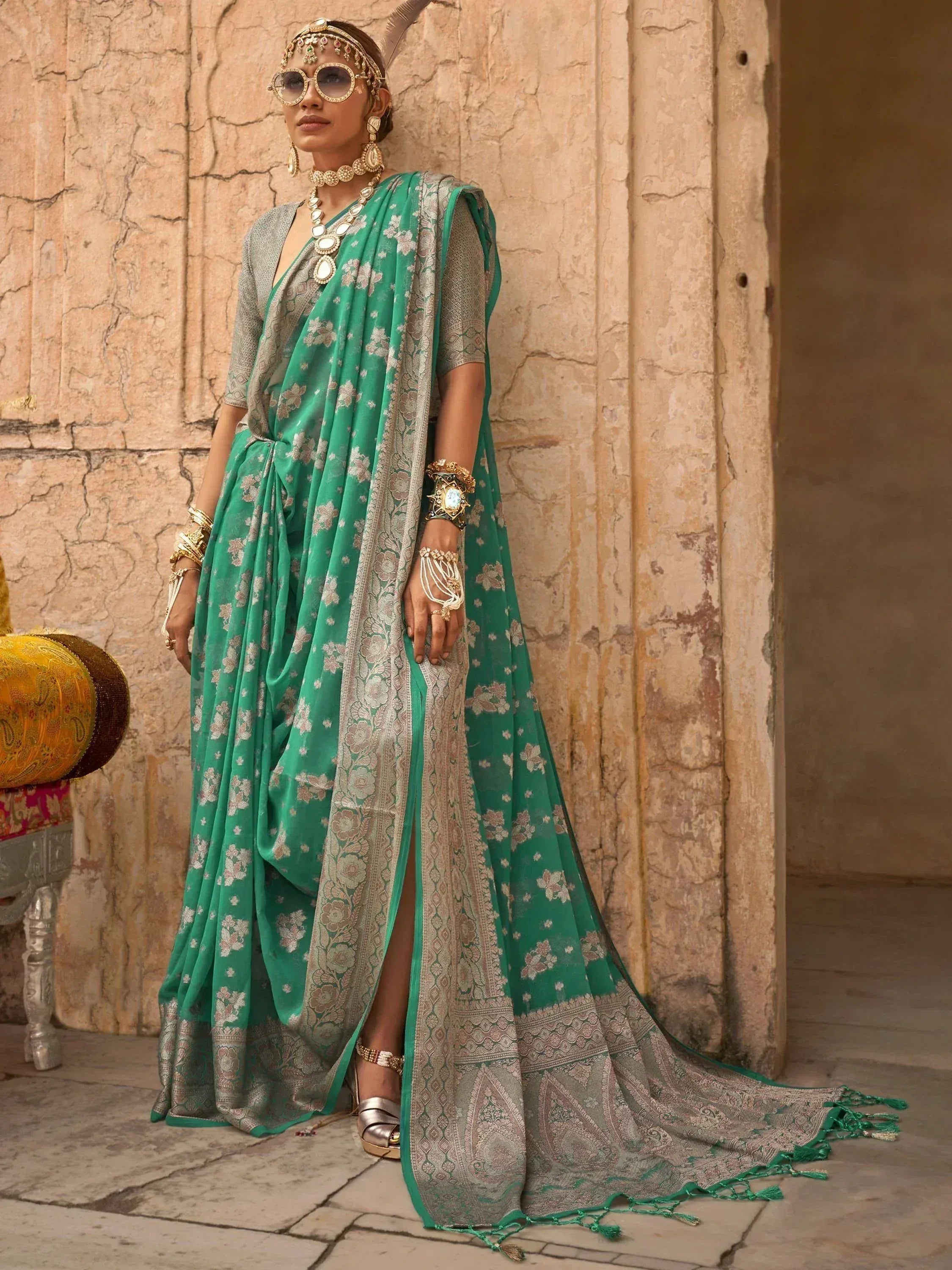 Emerald green floral saree with silver border, paired with designer jewelry and sunglasses for ethnic wear