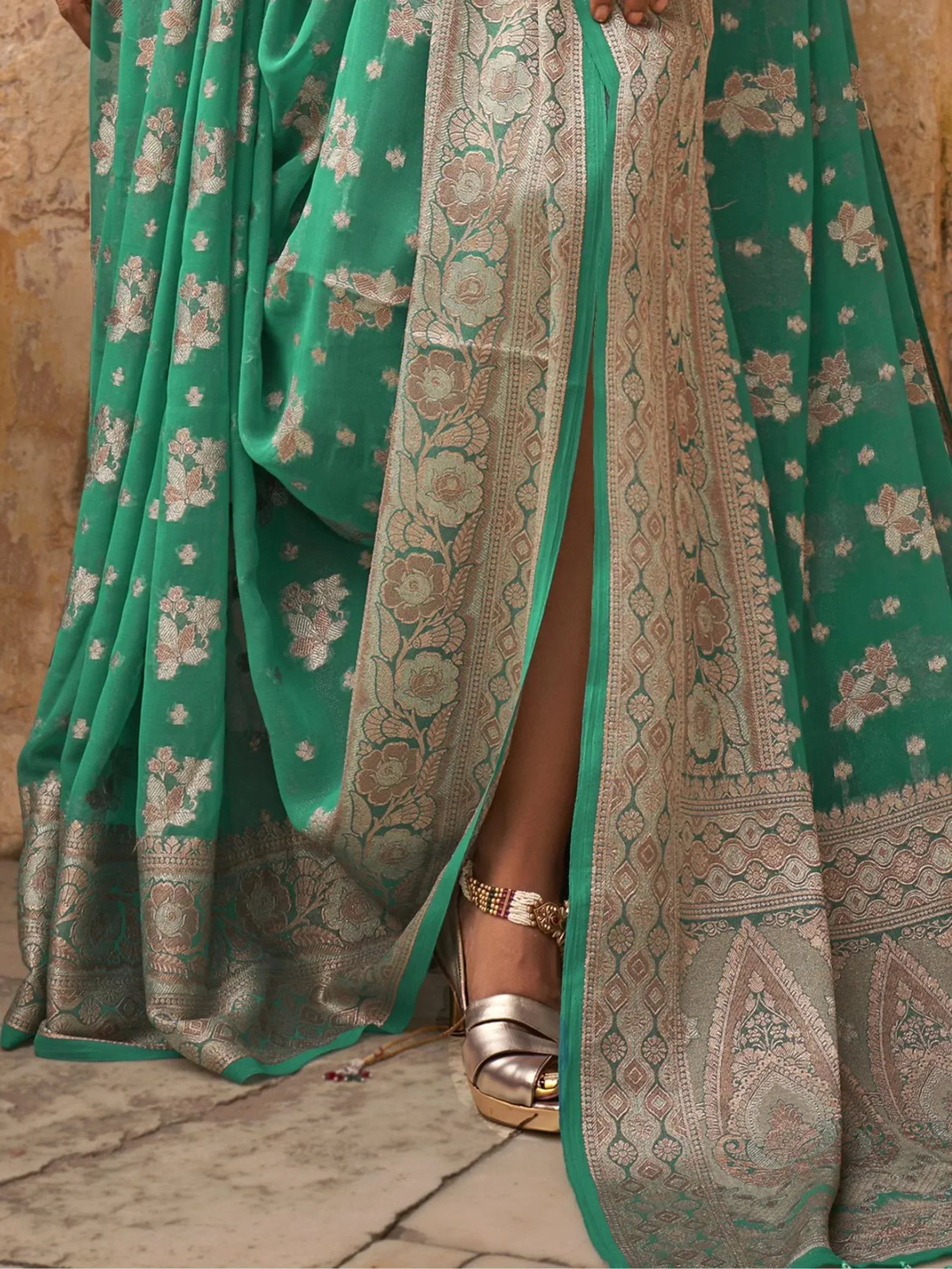Emerald green floral saree with gold zari border, perfect for Indian ethnic wear occasions