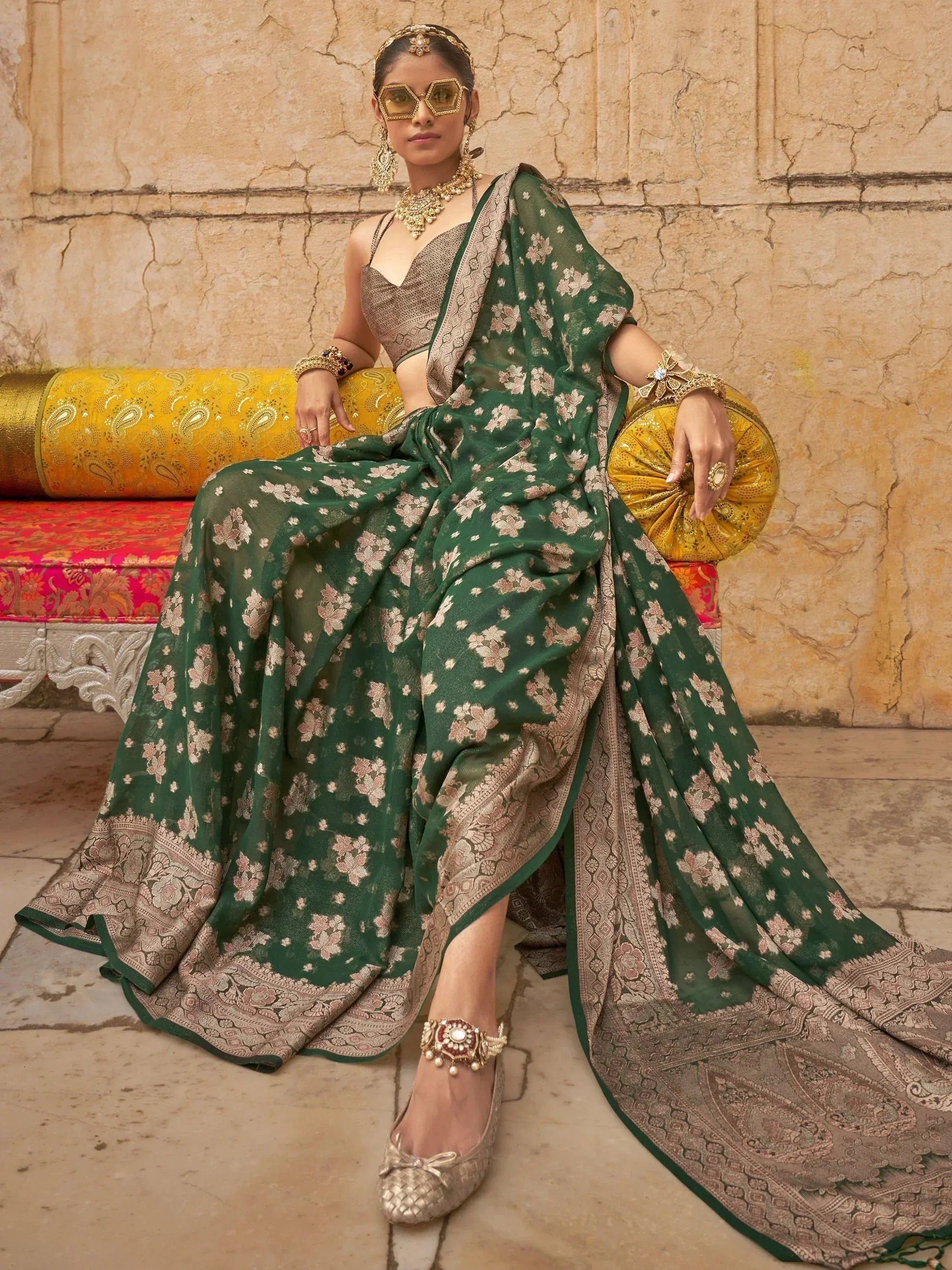Elegant green floral saree with gold border, paired with designer blouse and traditional jewelry for ethnic wear