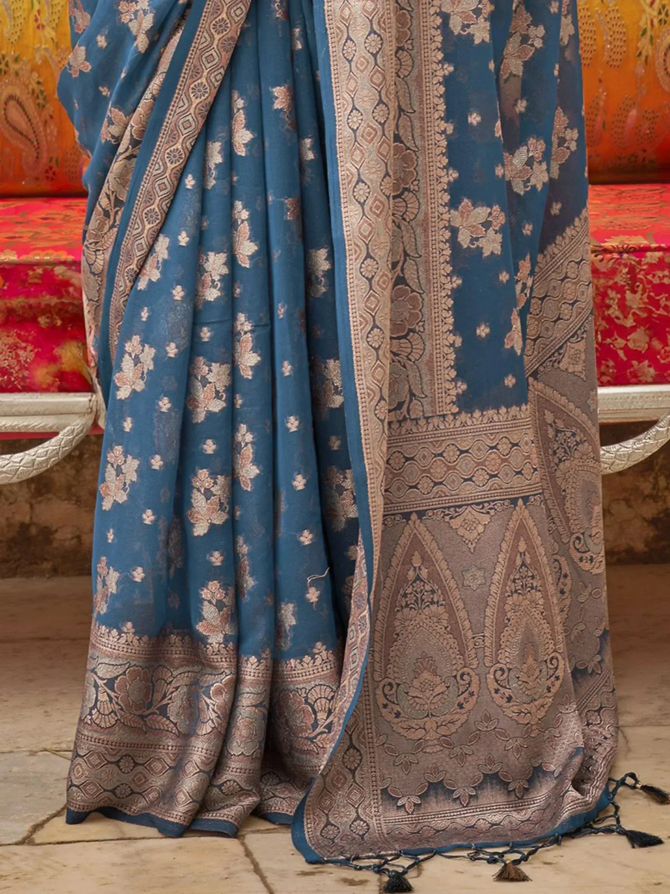 Blue floral ethnic saree with intricate gold border and paisley design, perfect for Indian occasions.