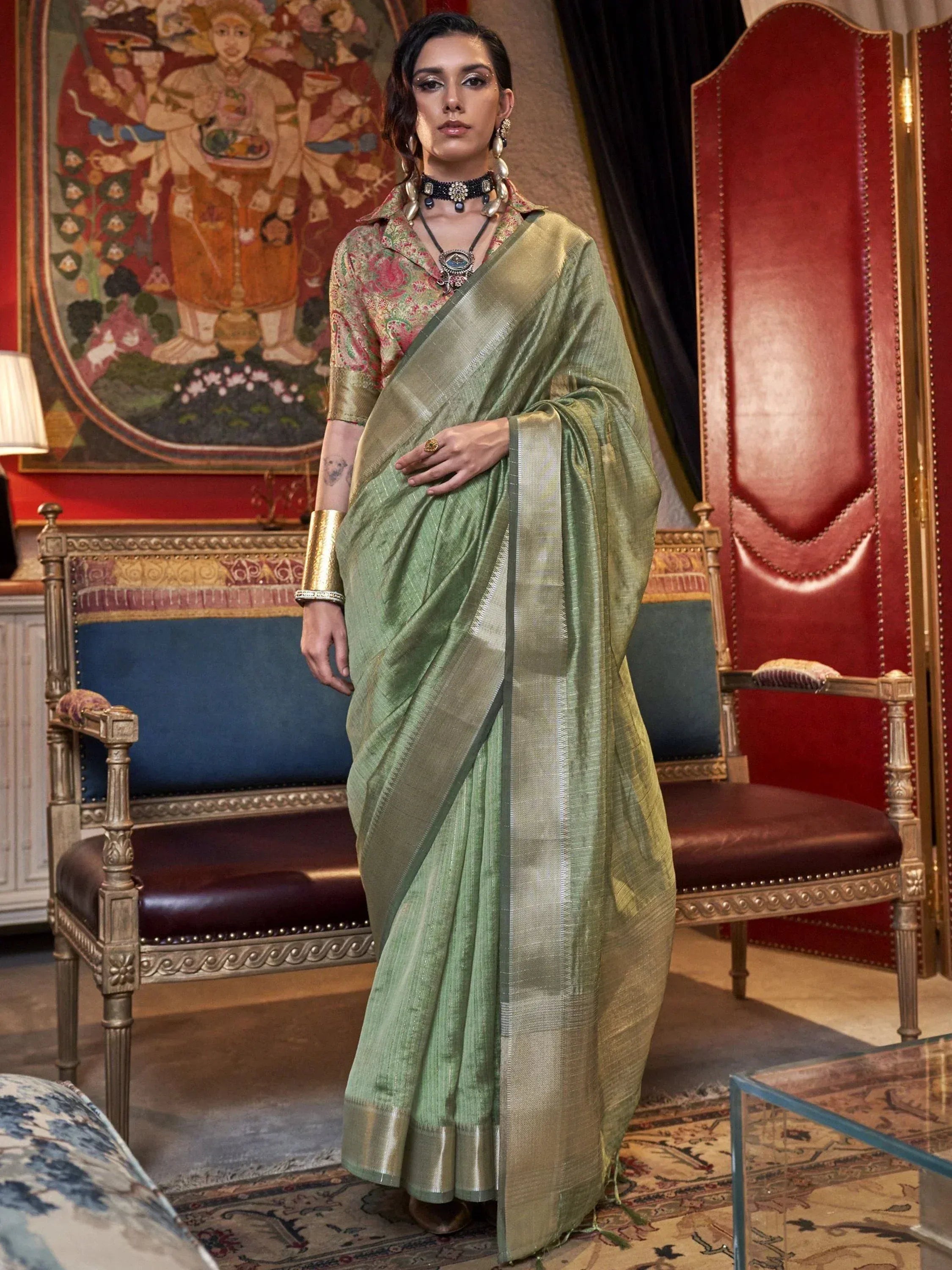 Elegant green silk saree with gold border, paired with printed blouse, perfect for Indian ethnic occasions