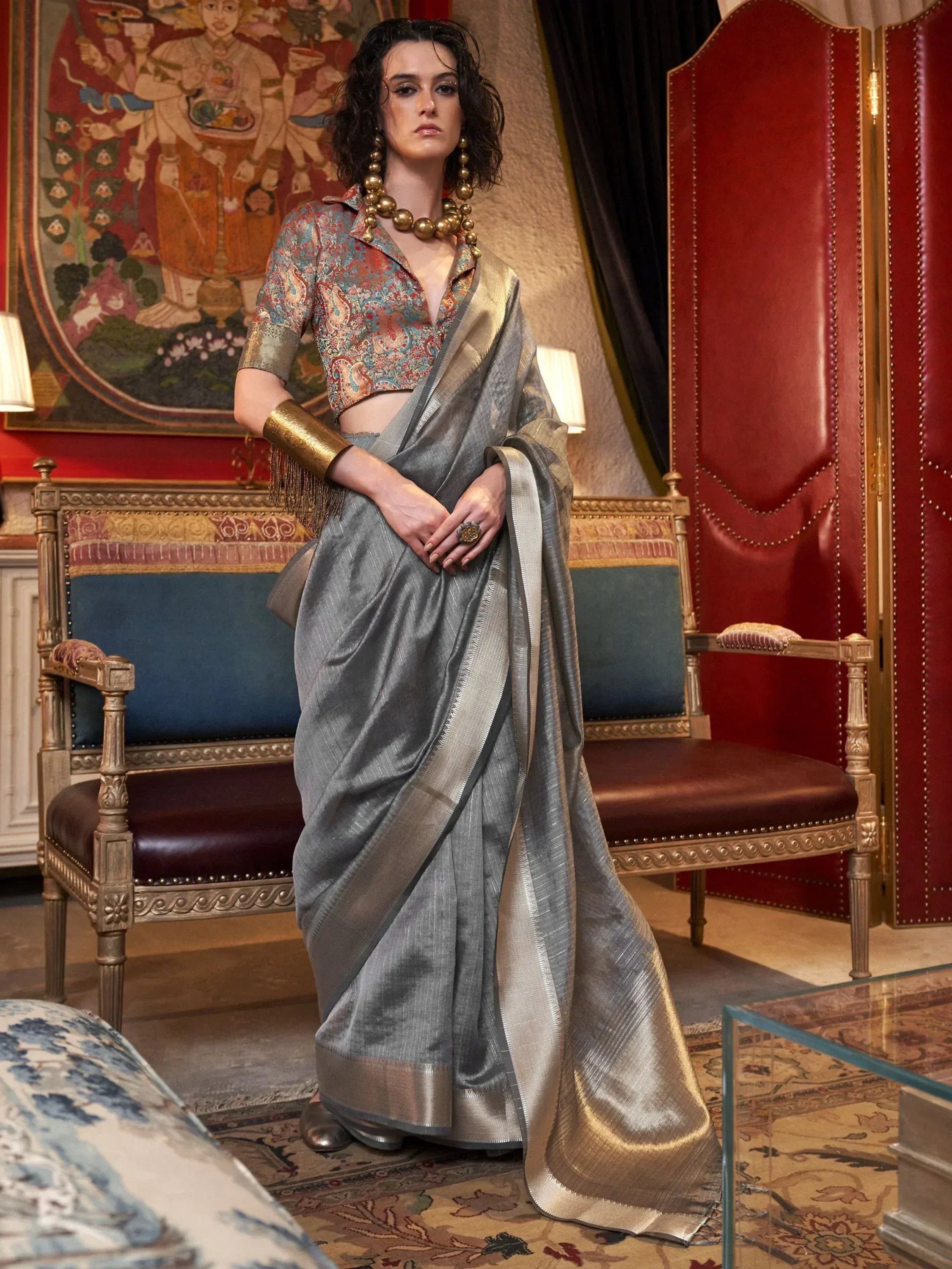 Elegant grey silk saree with gold border, paired with printed blouse, perfect for Indian ethnic occasions.
