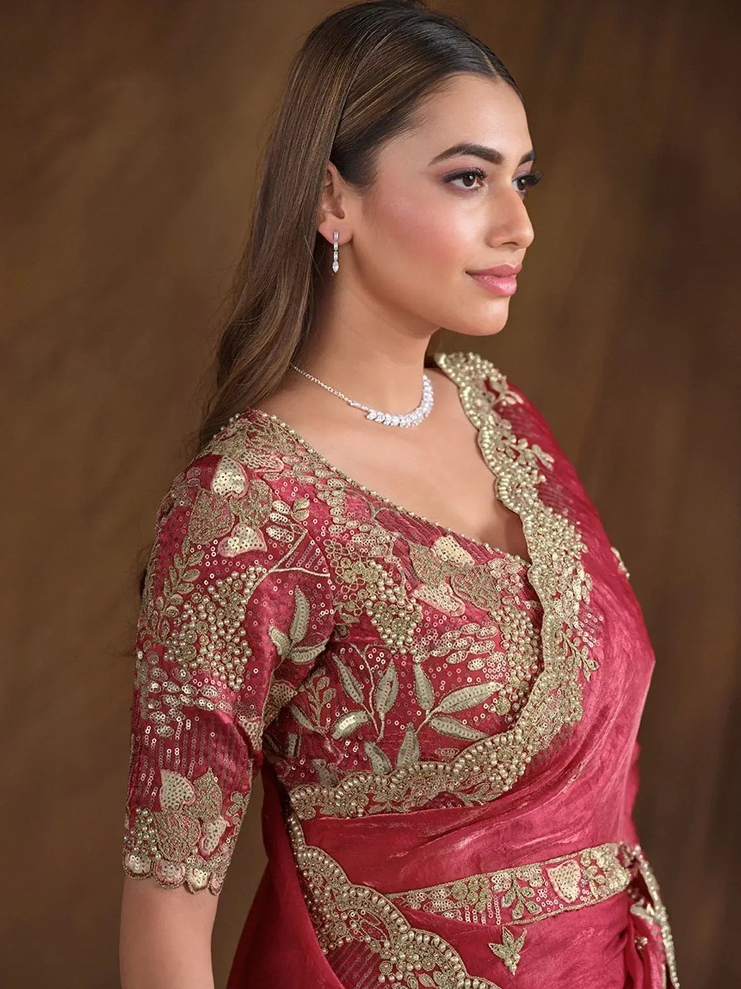 Elegant maroon ethnic gown with gold embroidery, perfect for Indian weddings and festive occasions.