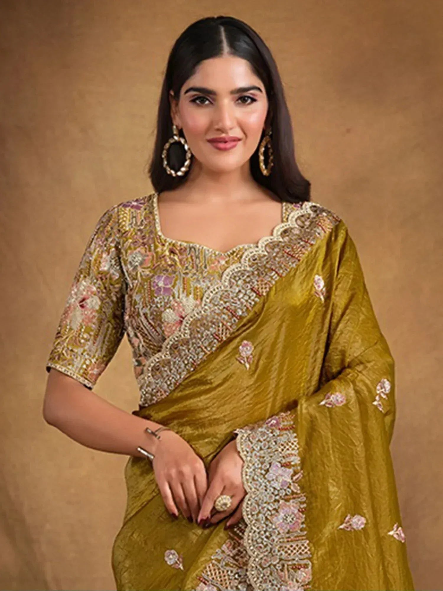 Elegant mustard yellow saree with intricate floral embroidery and embellished border, perfect for ethnic occasions