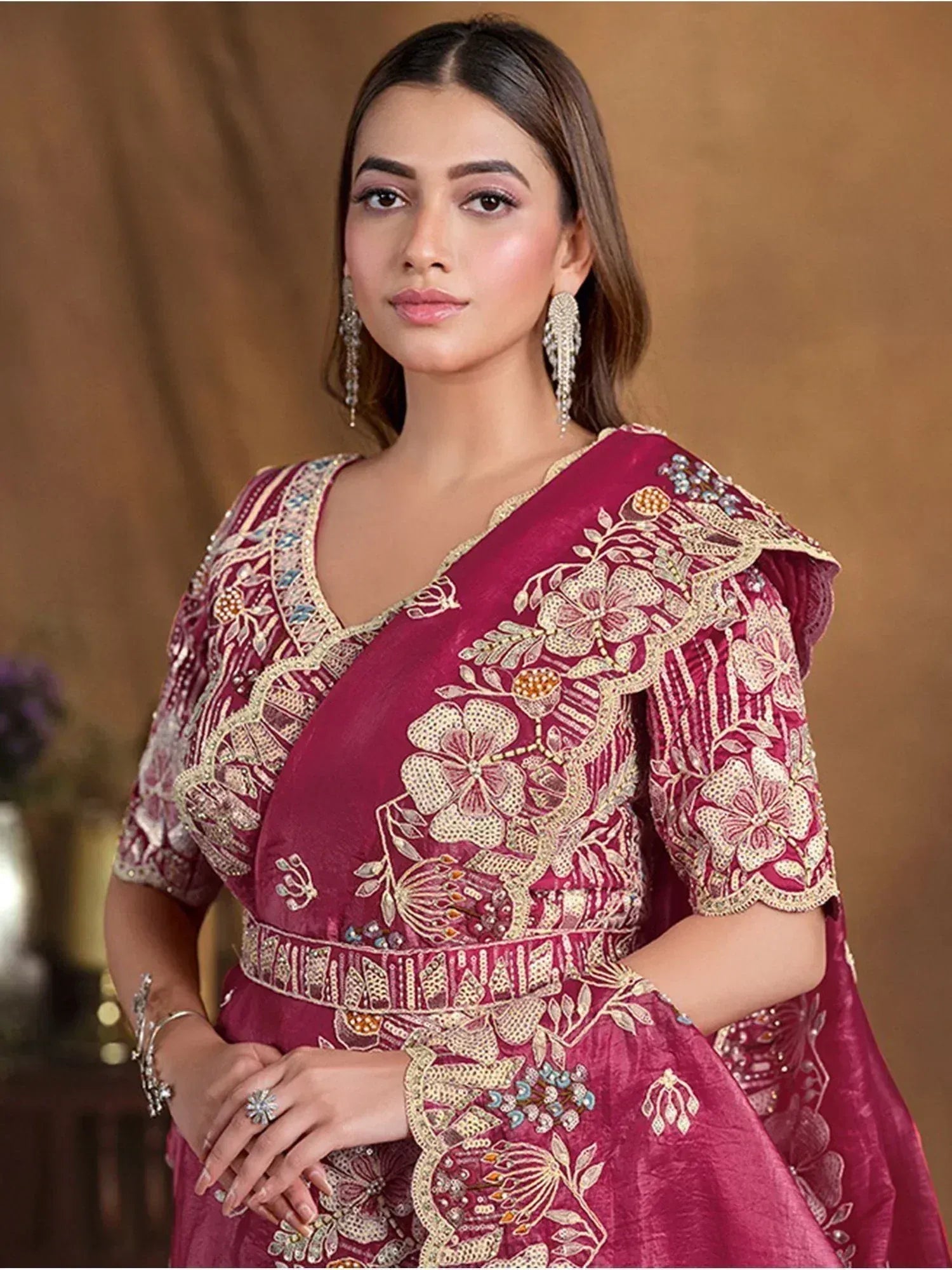 Maroon embroidered ethnic gown with floral gold detailing, perfect for Indian weddings and festive occasions.