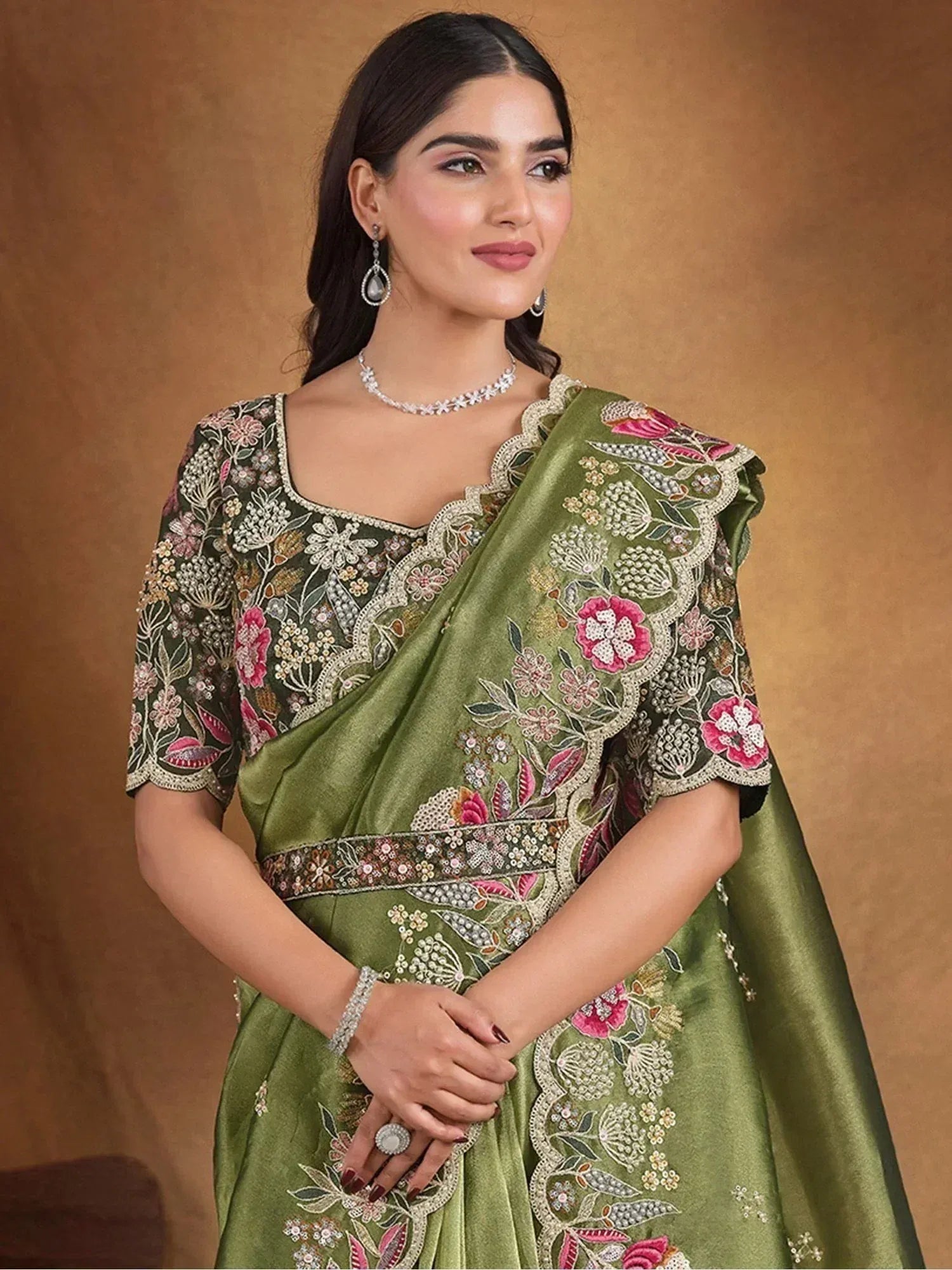 Green embroidered saree with floral motifs, perfect for Indian ethnic wear and festive occasions.