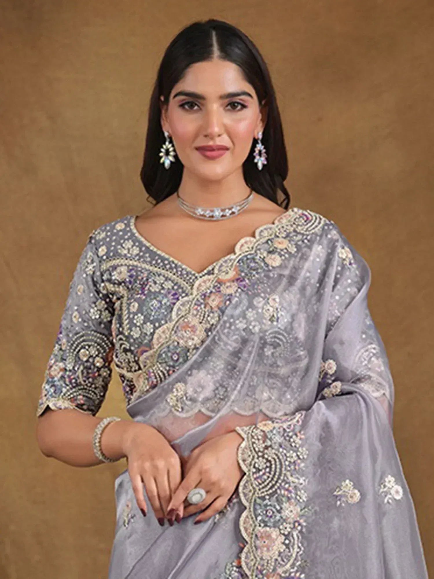 Elegant grey embroidered saree with floral motifs and scalloped border, perfect for Indian ethnic occasions.